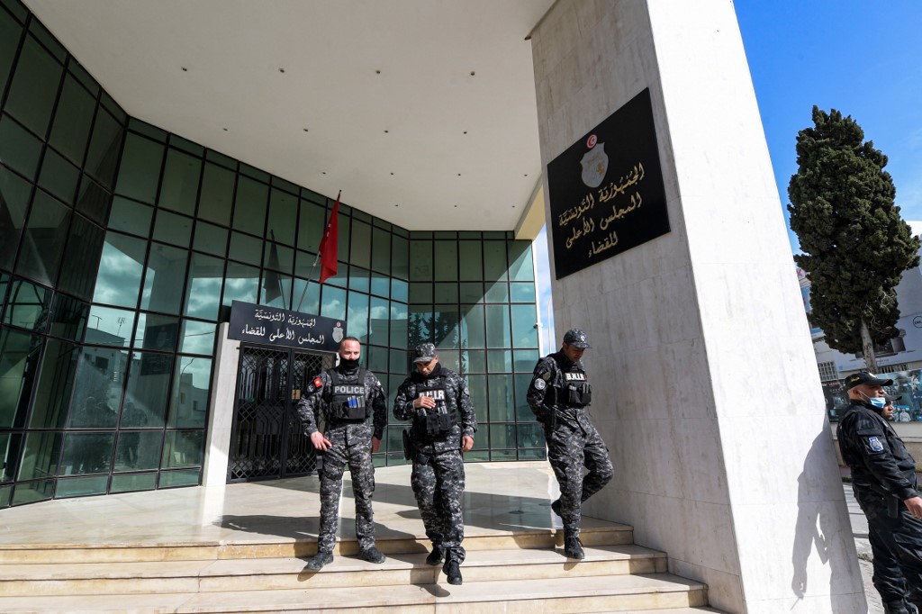 Members of the Tunisian security forces stand outside the closed entrance to the headquarters of Tunisia's Supreme Judicial Council (CSM) on 6 February 2022. (AFP)