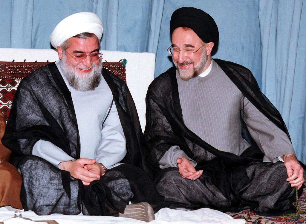 Iranian president Mohammad Khatami (R) shares a laugh with former deputy parliament speaker and new member of Iran's Council of Experts, Hasan Rohani, on the last day of the council's three-day meeting in Tehran 30 August 2000