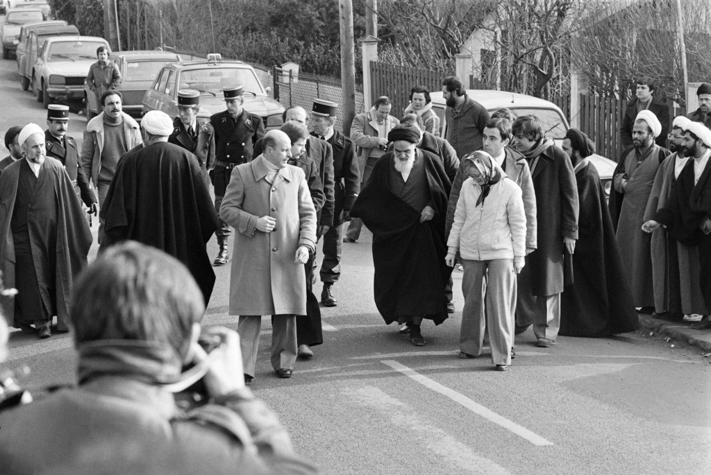 Rouhani (2nd R) s seen among companions of opposition leader in exile ayatollah Ruhollah Khomeiny (C-white beard) walking out of his villa in Neauphle-Le-Château near Paris on January 31, 1979 before boarding an Air France "Jumbo Jet" bound to Tehran (AFP)