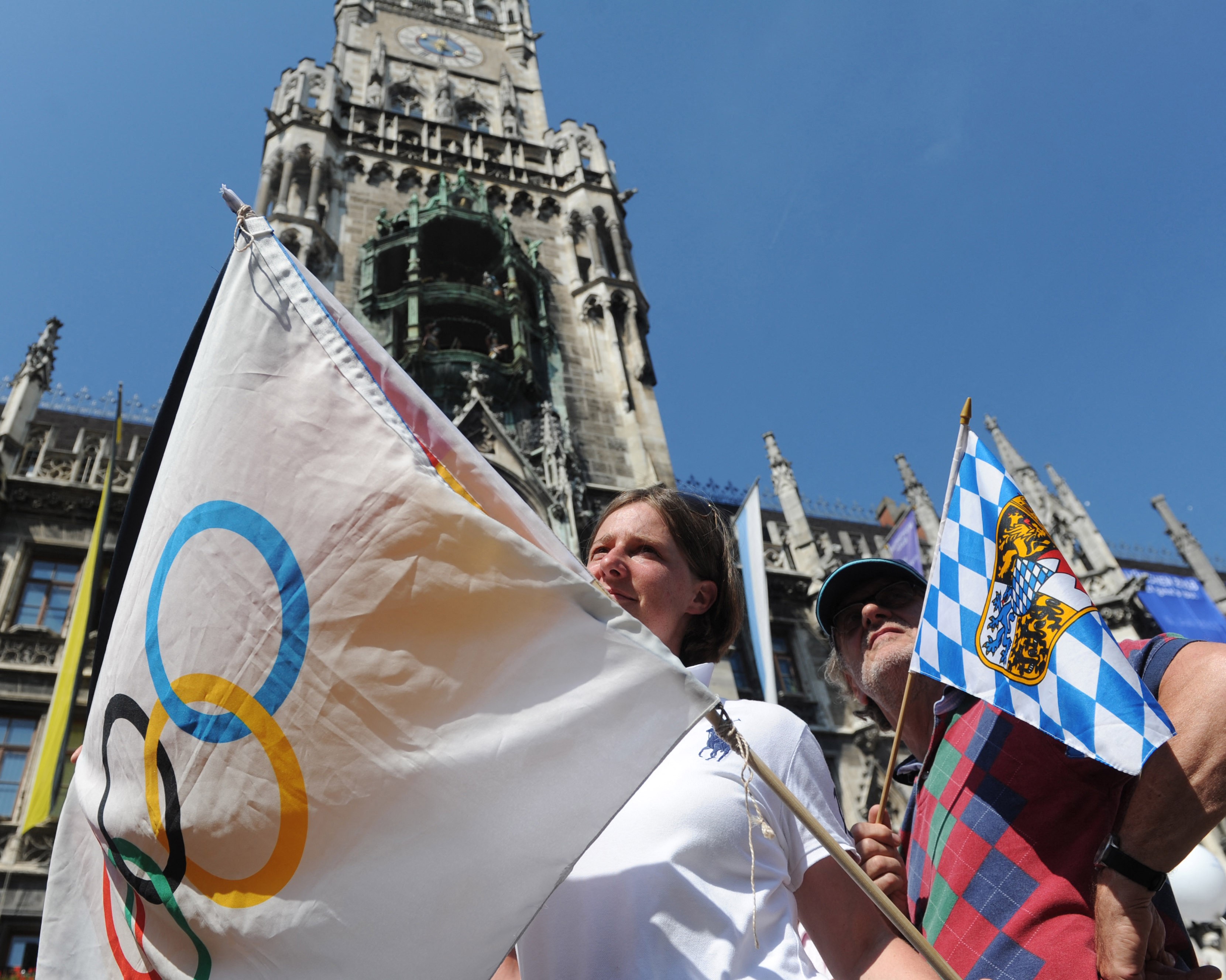 A woman holds a Olympic flag during the IOC announcement that Pyeongchang in South Korea will host the 2018 Winter Olympics at Marienplatz in Munich, southern Germanyon July 6, 2011 Munich 