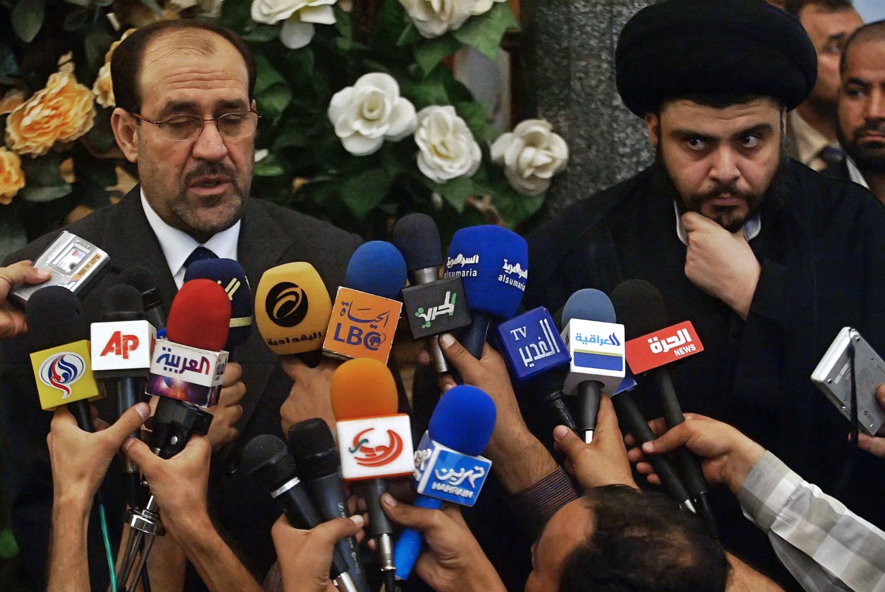 Then-Iraqi Prime Minister Nouri al-Maliki (L) speaks during a joint press conference with Shia cleric Muqtada al-Sadr upon their meeting in Najaf, central Iraq, 18 October 2006 (AFP)