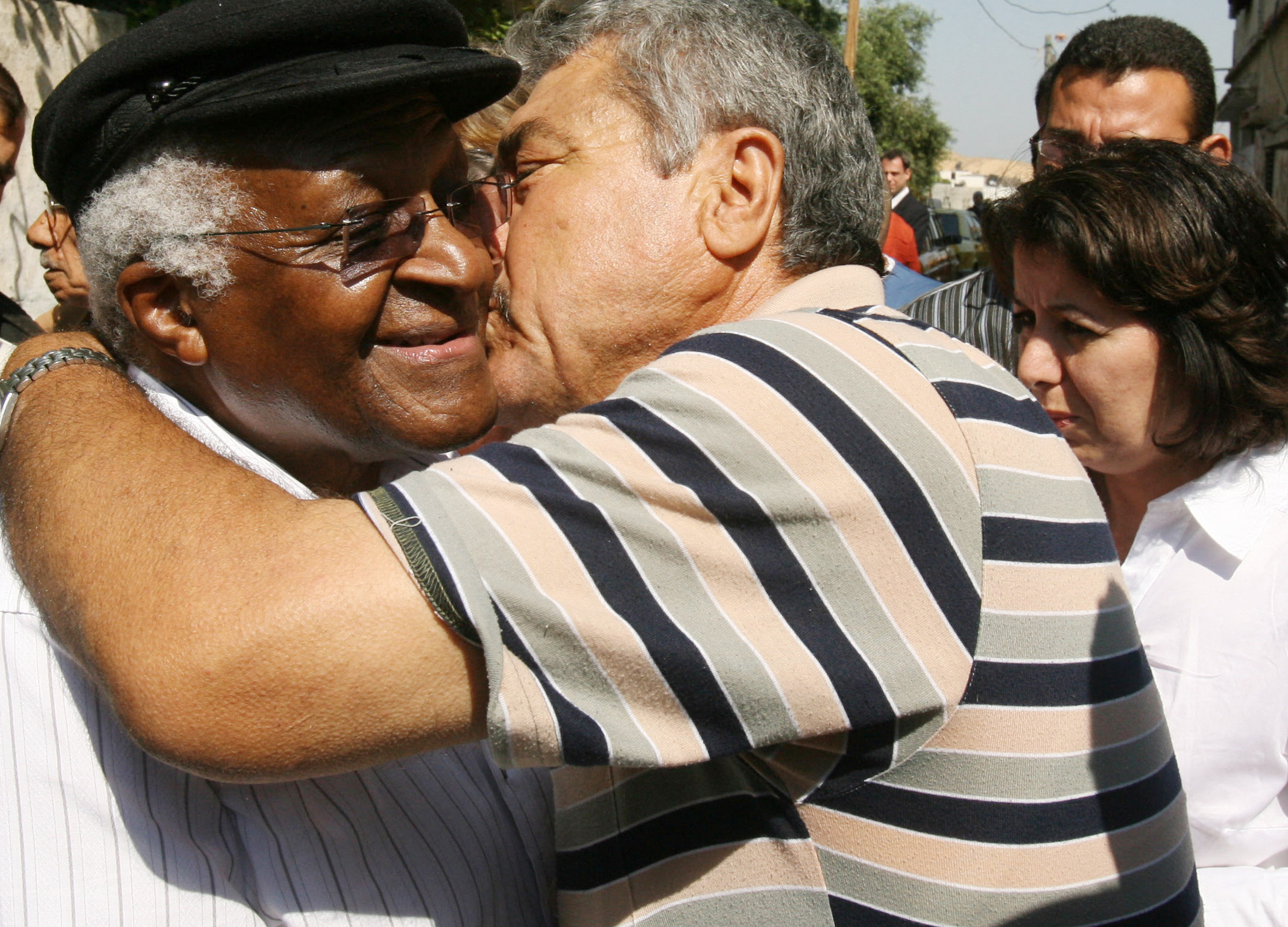 A member of the Palestinian al-Asamneh family embraces Nobel peace laureate Desmond Tutu during his visit to the family in Beit Hanun in the northern Gaza Strip on May 28, 2008.