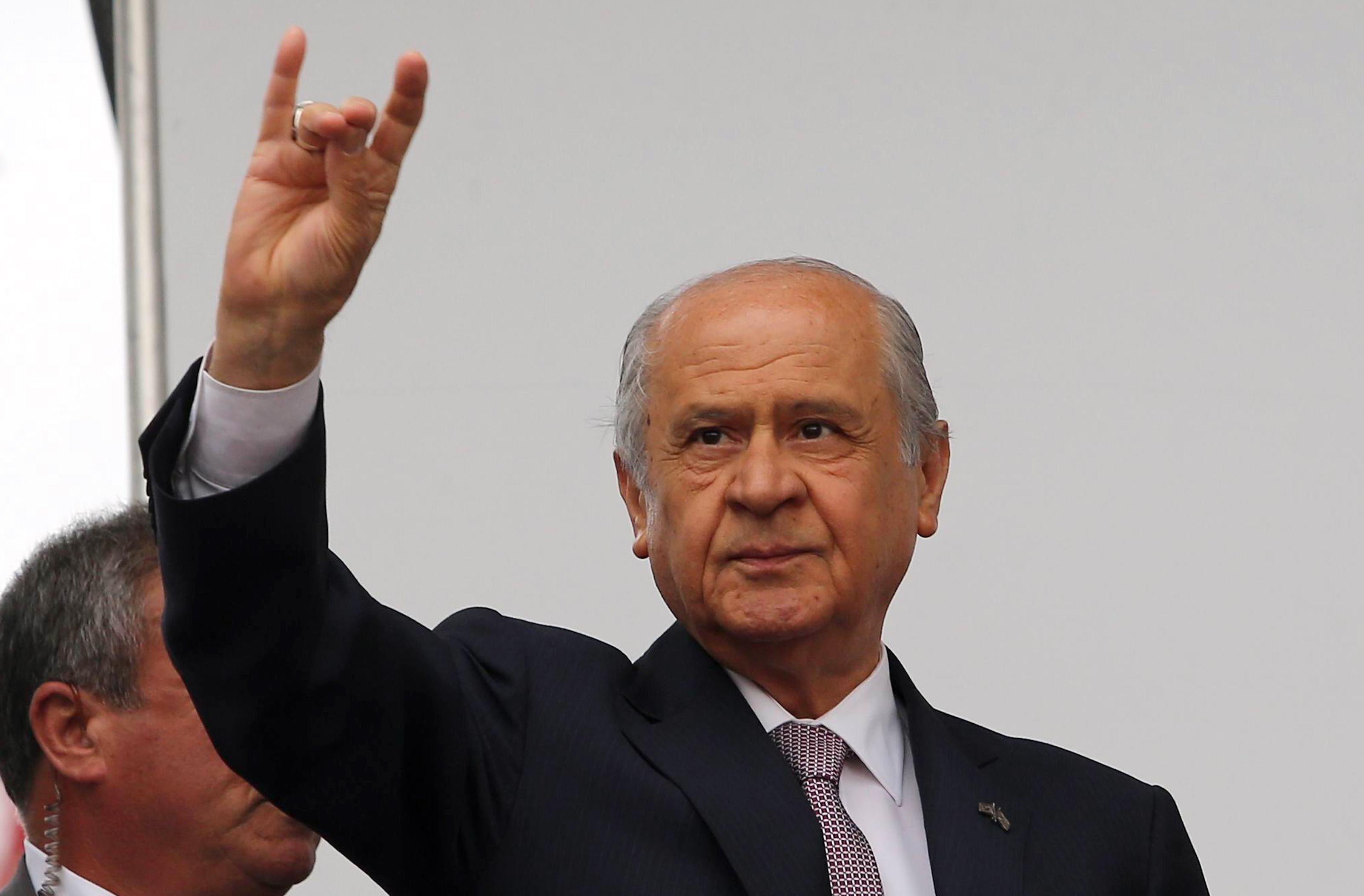 Turkey's opposition leader of the Nationalist Action Party (MHP) Devlet Bahceli gestures the "Grey Wolves" sign during an election rally on May (AFP)