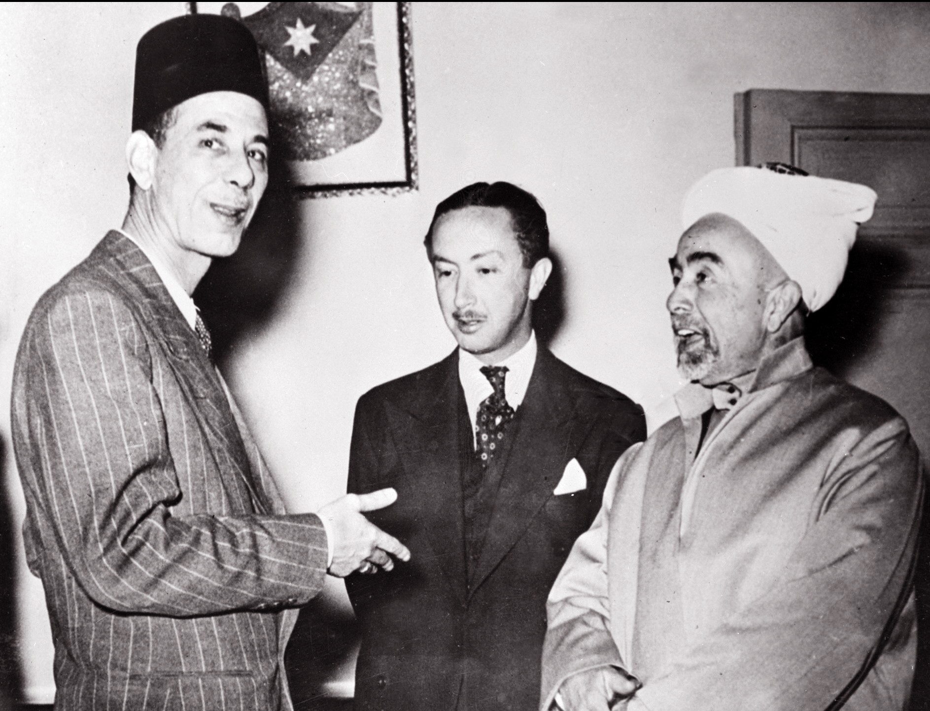 King Abdullah (r) of Transjordan (later Jordan), Commandant of the Allied Arab forces, talks 13 May 1948 in Amman with Abed al-Rahman Azzam (l), the secretary general of the Arab League and Abd al-Elah Ibn Ali, the Prince Regent of Iraq, the day before the beginning of the first Arab-Israeli War. 