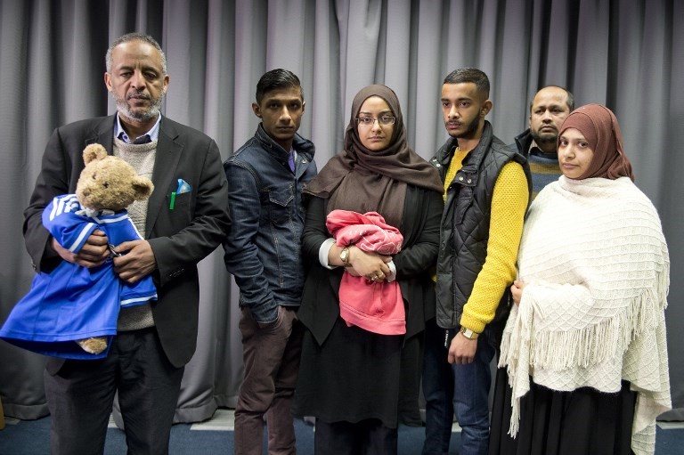 The families of missing British girls Amira Abase and Shamima Begum pose for a picture after being interviewed by the media in central London, on 22 February, 2015 (AFP)