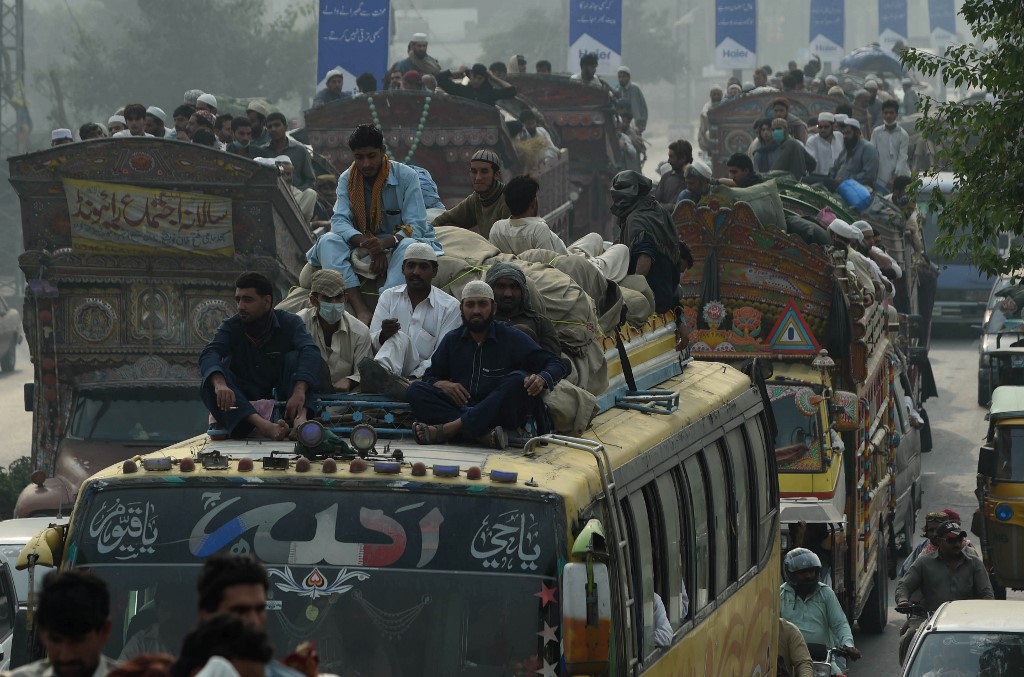 Pakistani passengers sit atop buses as they make their way home from the three-day annual Tablighi Ijtema religious gathering in Raiwind on the outskirts of Lahore on November 6, 2016.