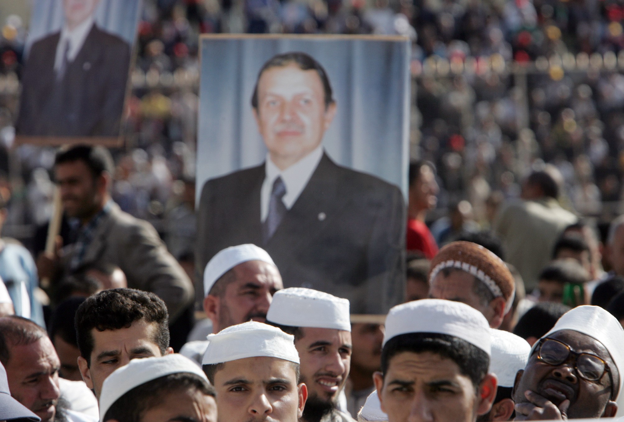 Islamist supporters of Bouteflika hold his portrait as they attend a rally in Tizi-Ouzou on 19 September 2005 (AFP)