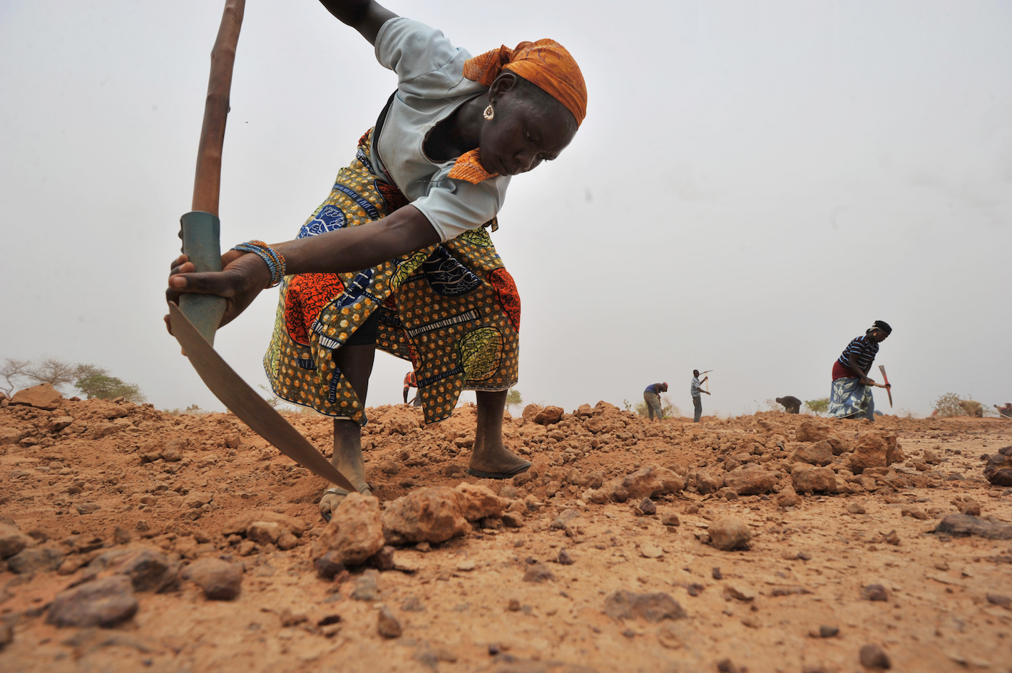 A Nigerian woman digs a trench to collect rainwater near the village of Tibiri in 2012 (AFP)