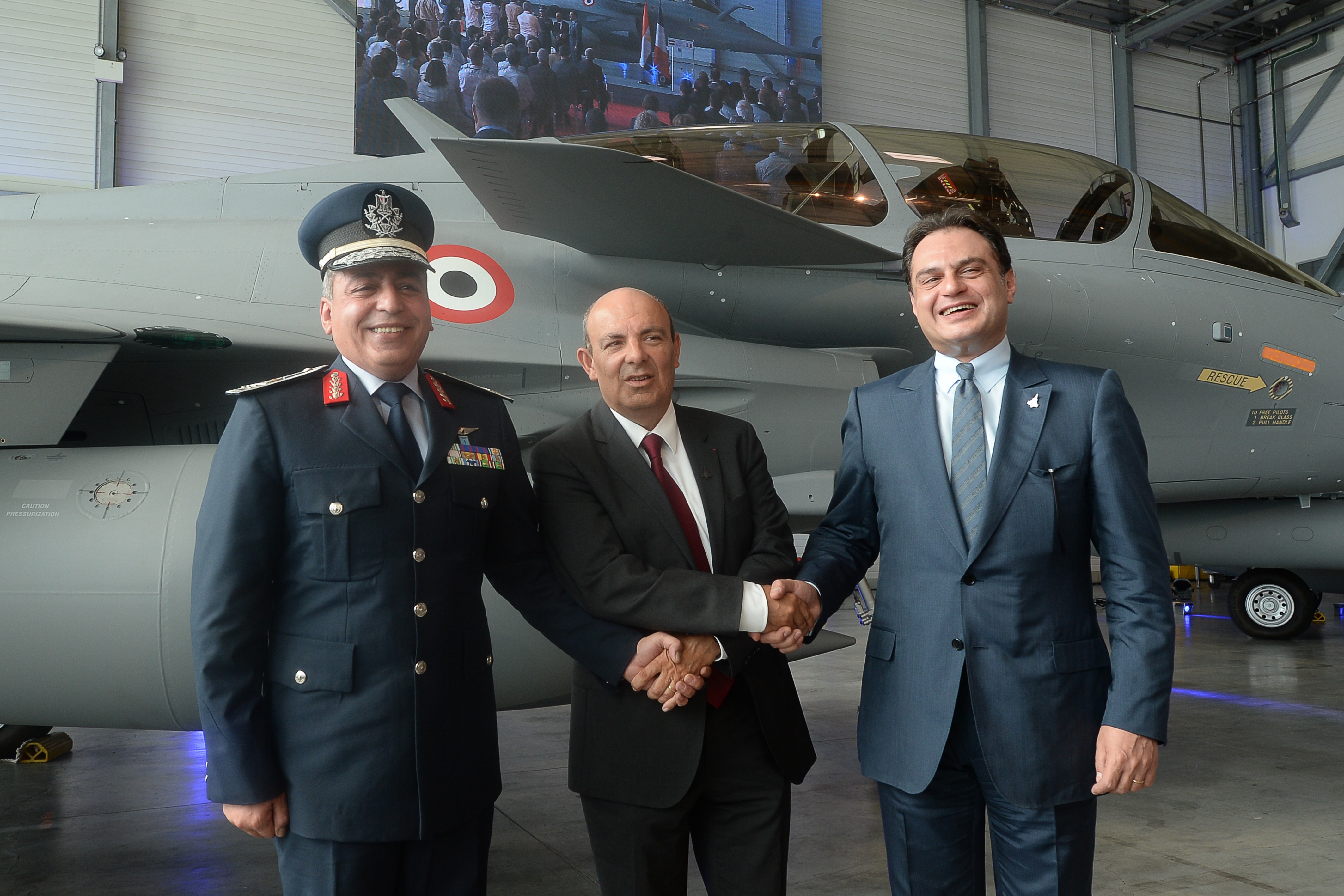 Ehab Badawy (right), Egyptian ambassador to France, Eric Trappier, chairman of Dassault Aviation and Major General Ragaa Khalil are pictured with a Rafale fighter jet in 2015 (AFP