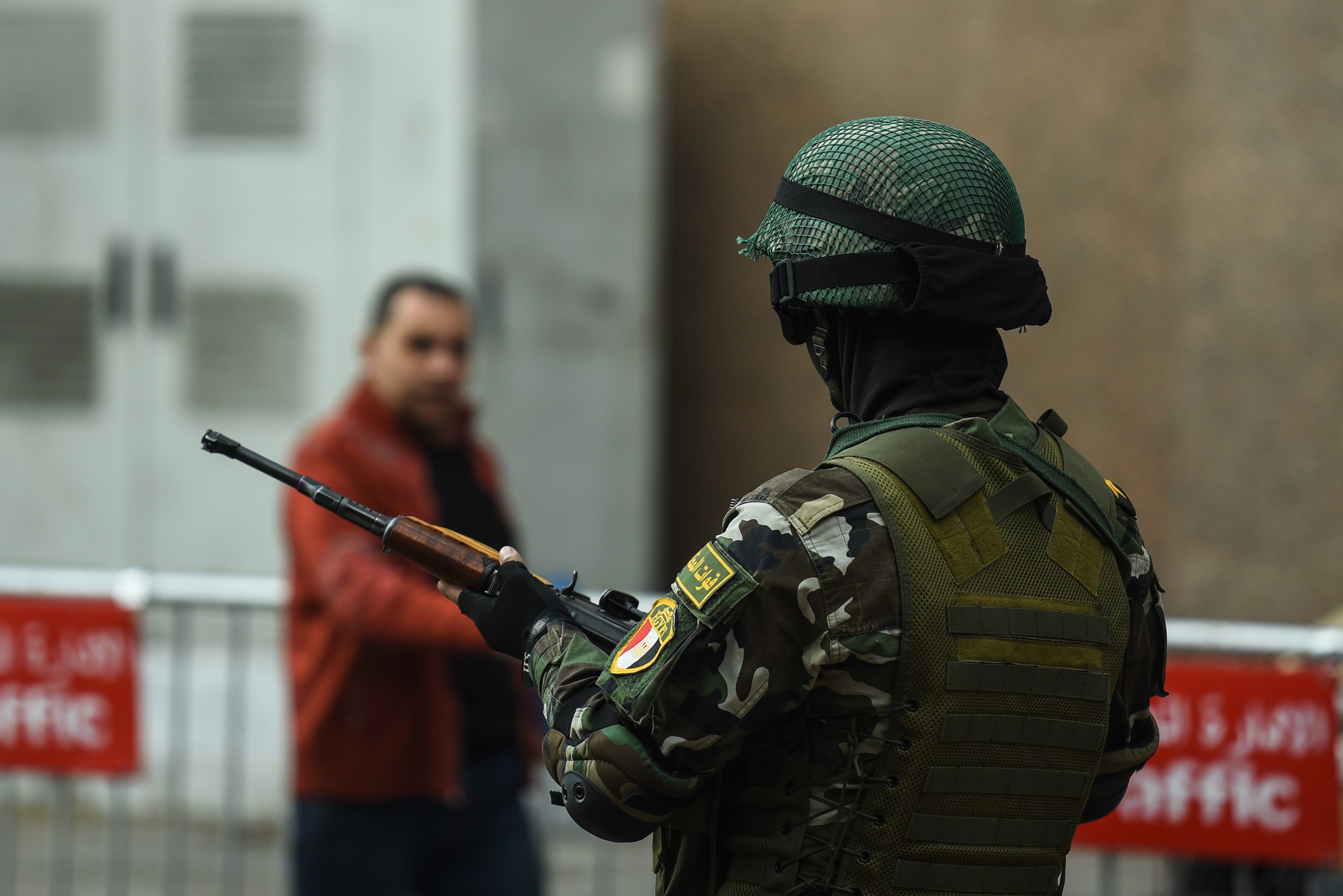 A member of the Egyptian special forces stands guard in front of the National Election Authority in Cairo (AFP)