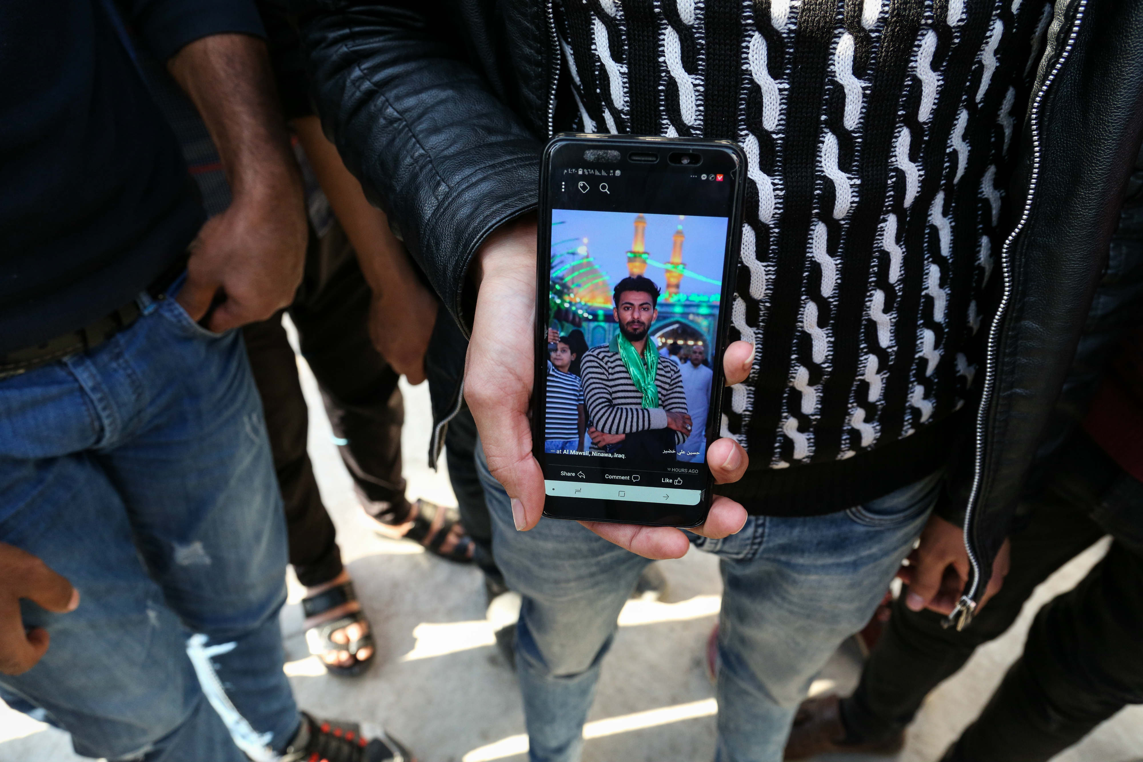 An Iraqi shows a photo of a missing relative (MEE/Thea Pedersen)