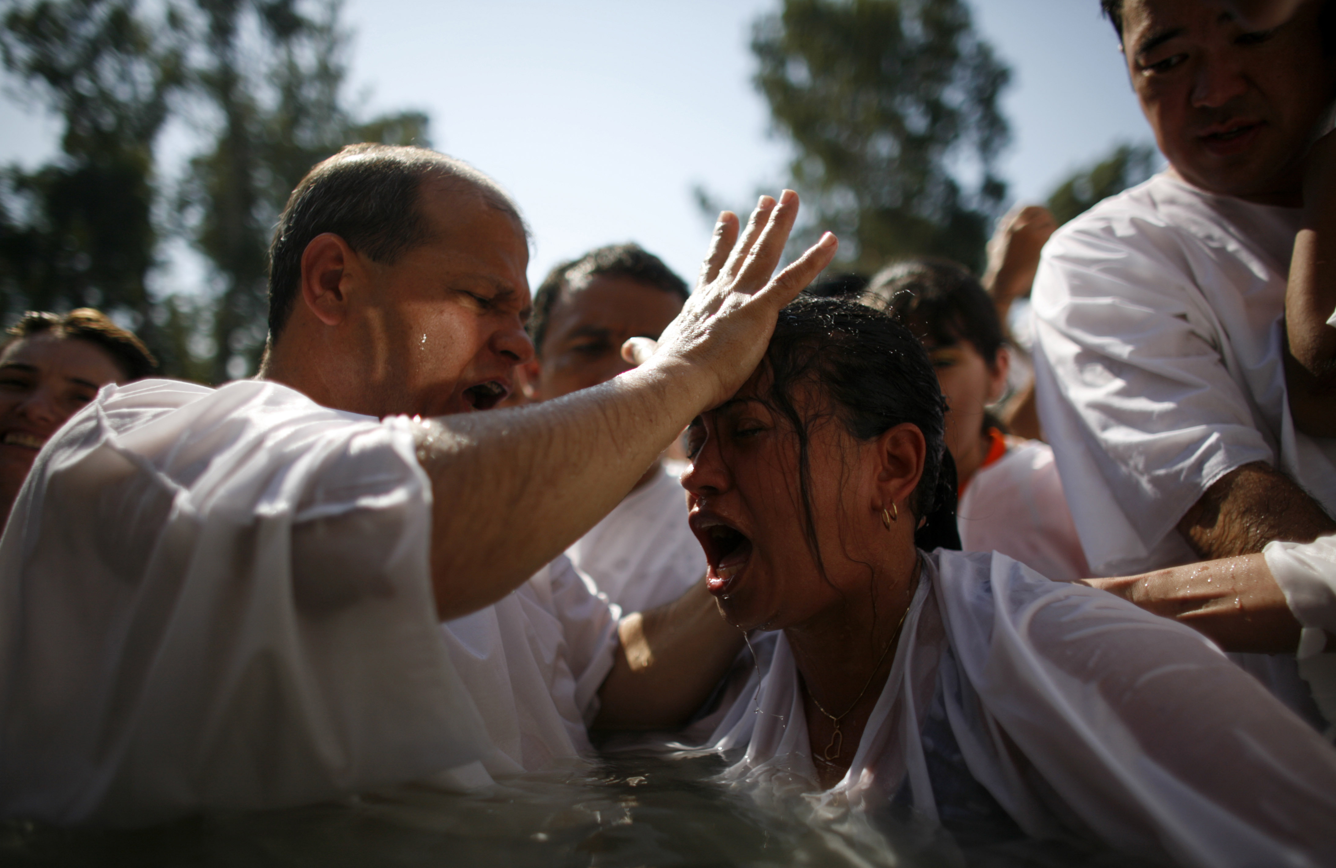 A group of evangelical Christian pilgrims take part in a baptism ceremony in the Jordan River near the northern city of Tiberias (Reuters)