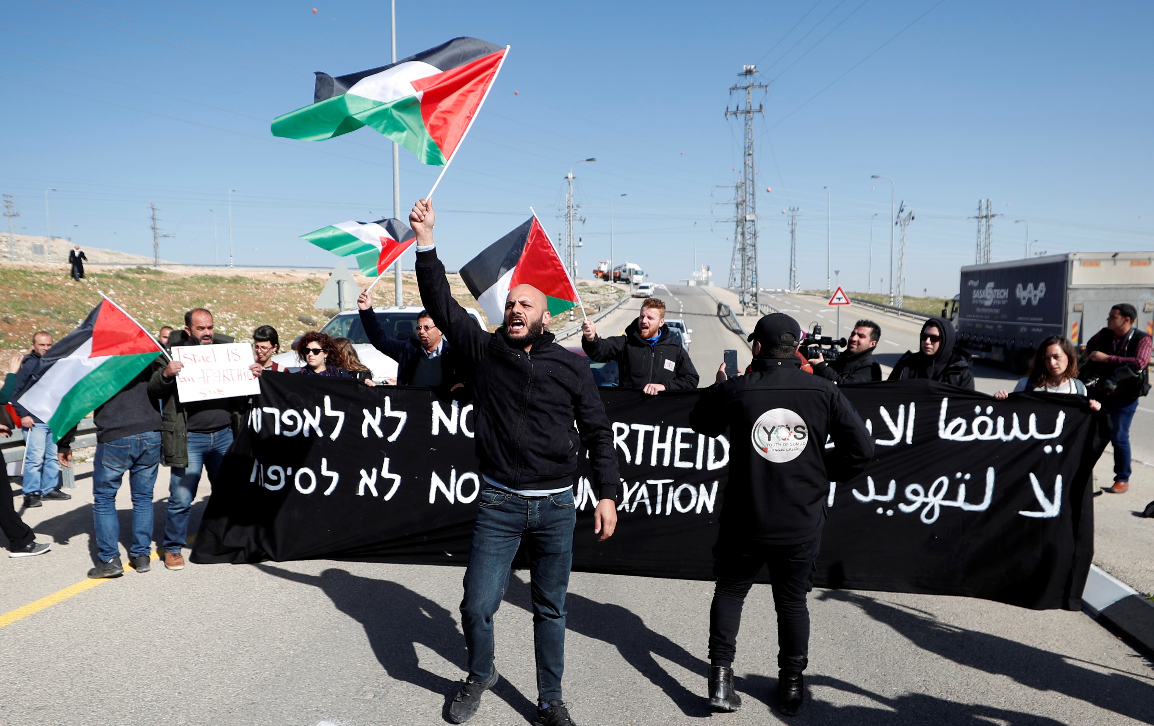 Activists in a protest in the village of Anata, in the Israeli-occupied West Bank, on the outskirts of Jerusalem 23 January (Reuters)