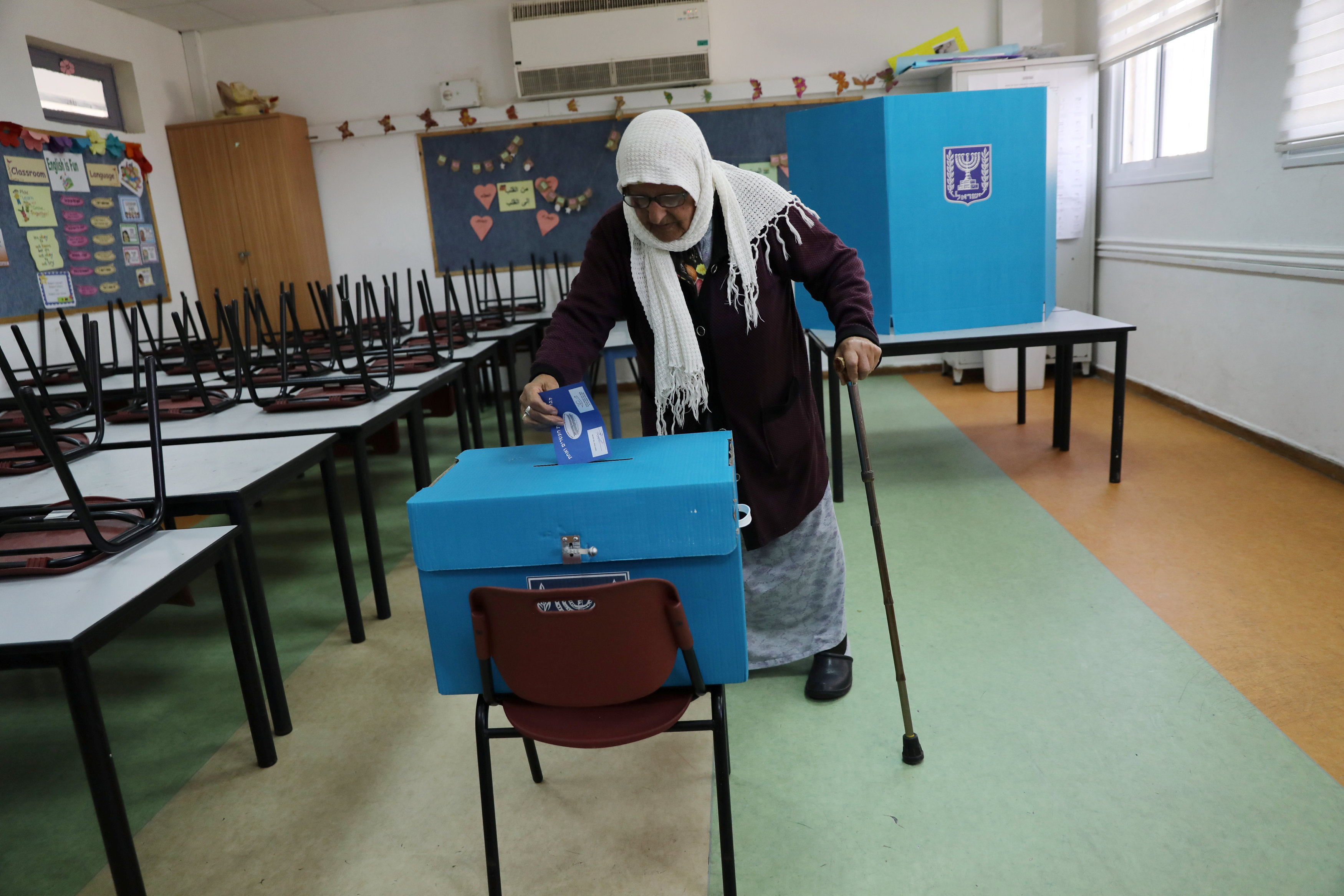 An Israeli-Arab woman casts her ballot as Israelis began voting in a parliamentary election, at a polling station in Haifa (Reuters)