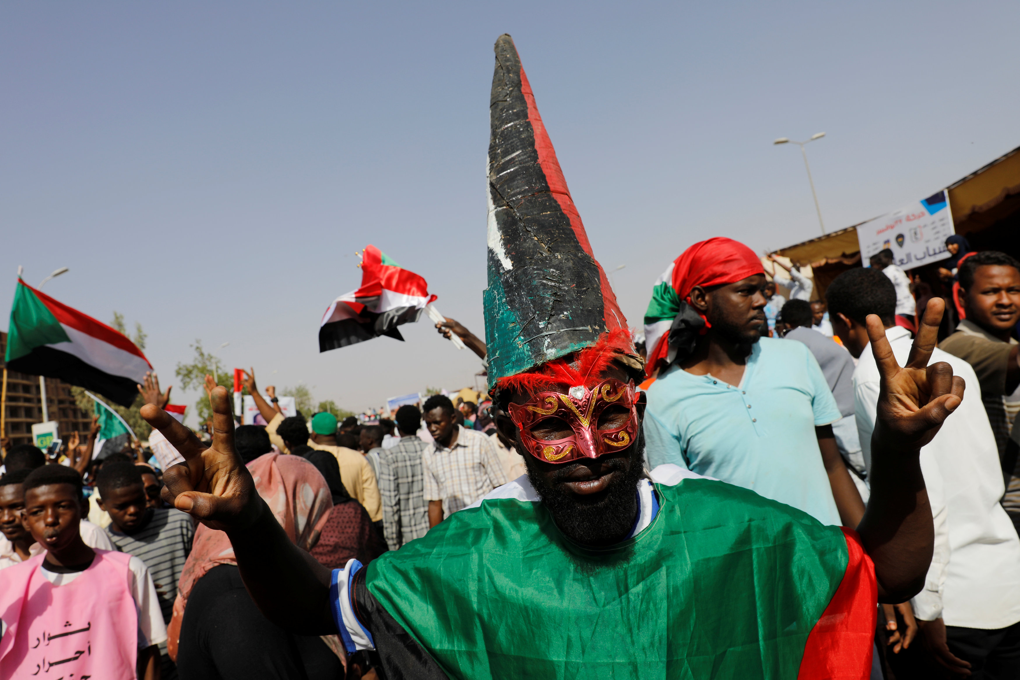 A Sudanese protester makes a victory sign outside the defence ministry compound in Khartoum (Reuters)