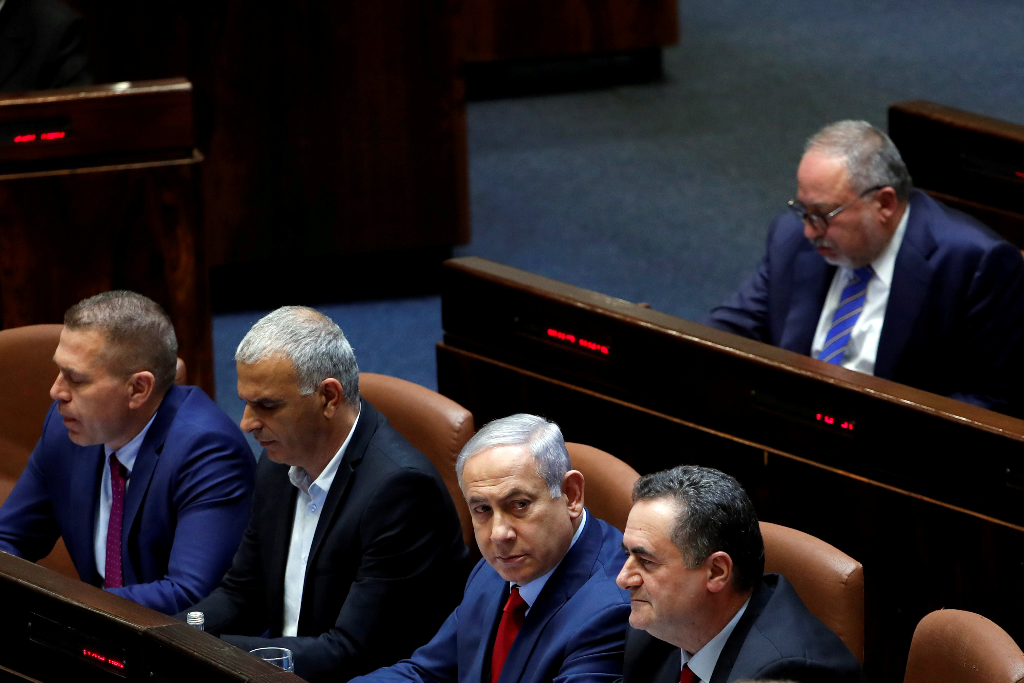Israeli Prime Minister Benjamin Netanyahu sits with his ministers and Israel's former defence minister Avigdor Lieberman at the plenum at the Knesset, Israel's parliament (Reuters)