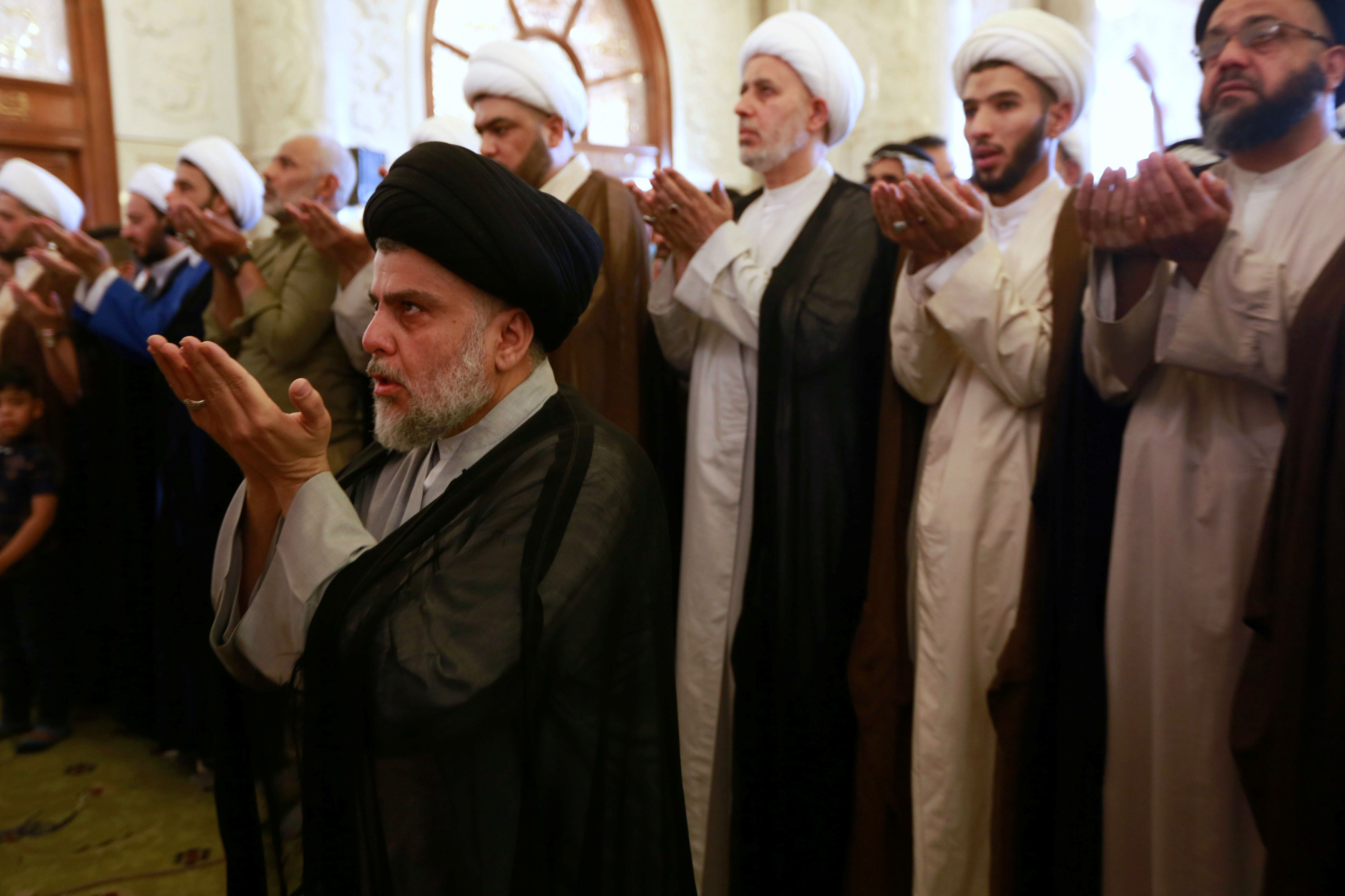 Muqtada al-Sadr performs Eid al-Fitr prayers marking the end of the fasting month of Ramadan at the Kufa Mosque near Najaf, Iraq (Reuters)