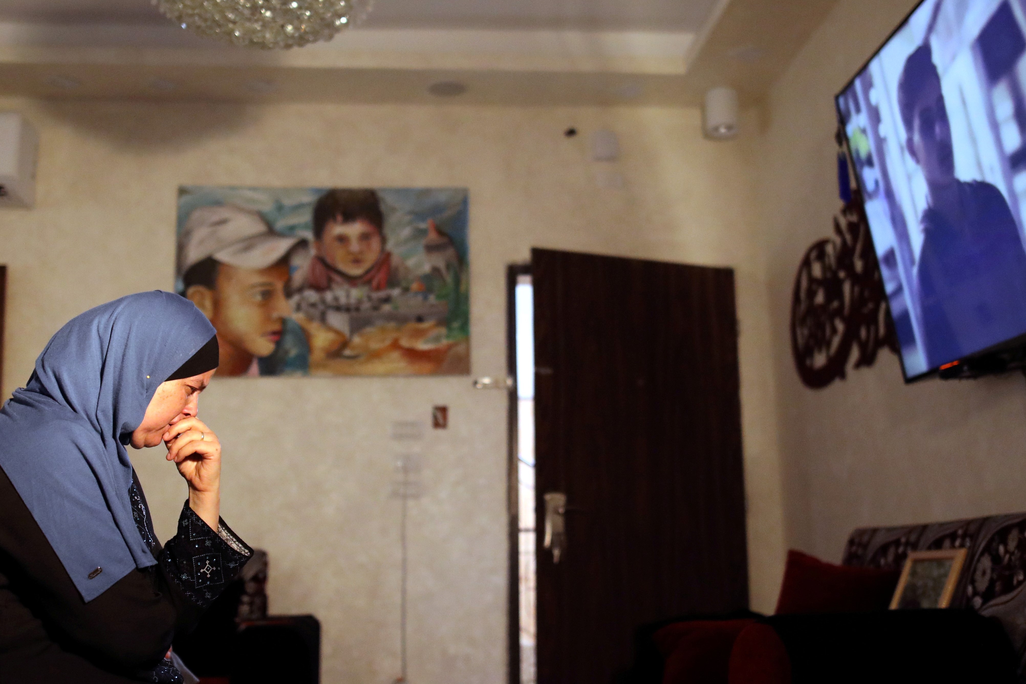  Suha Abu Khdeir, whose son's murder is the subject of the HBO series "Our Boys", watch the show's first two episodes in their East Jerusalem home on 18 August (Reuters)