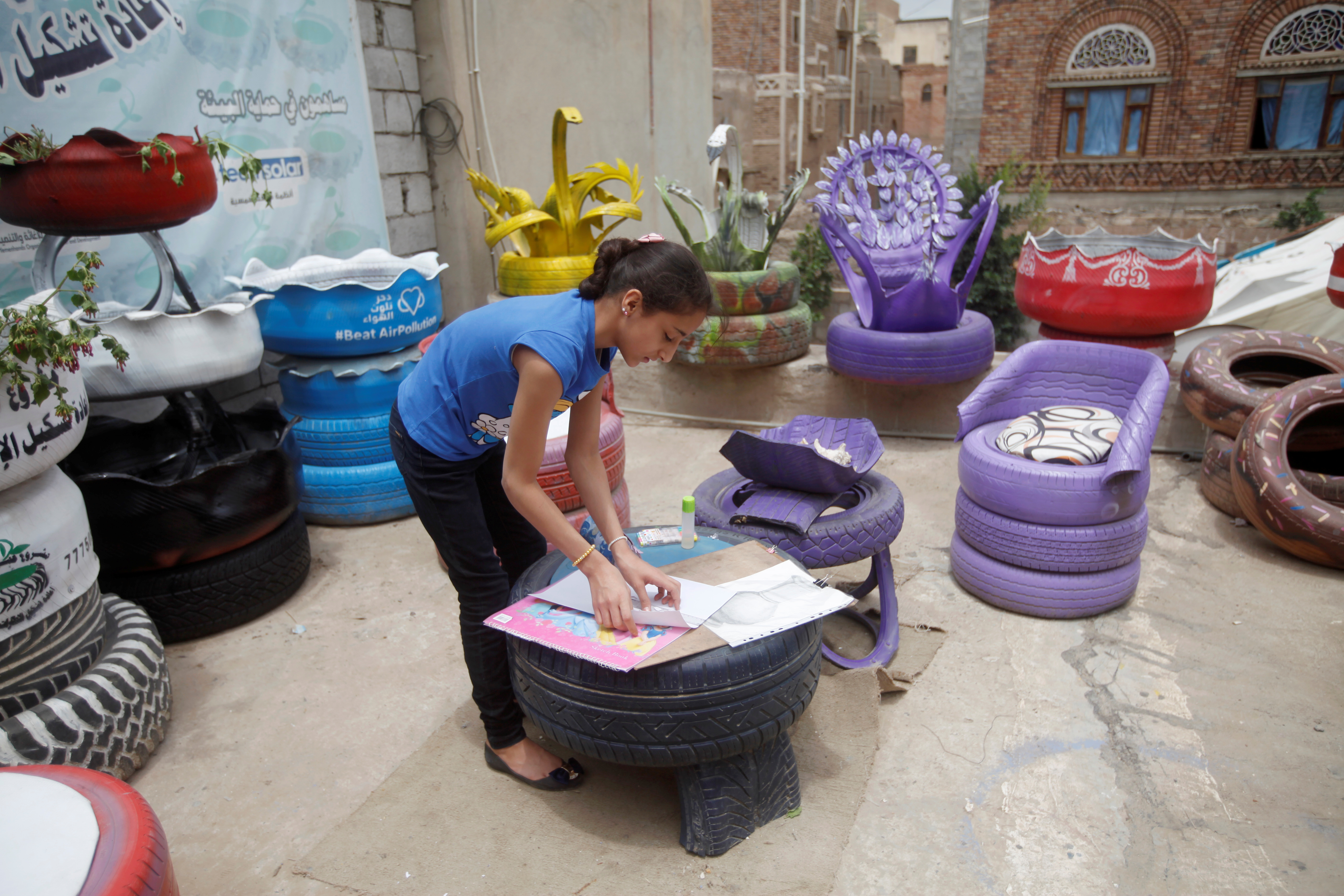 Yemeni girl works at workshop that upcycles used tyres in Sanaa