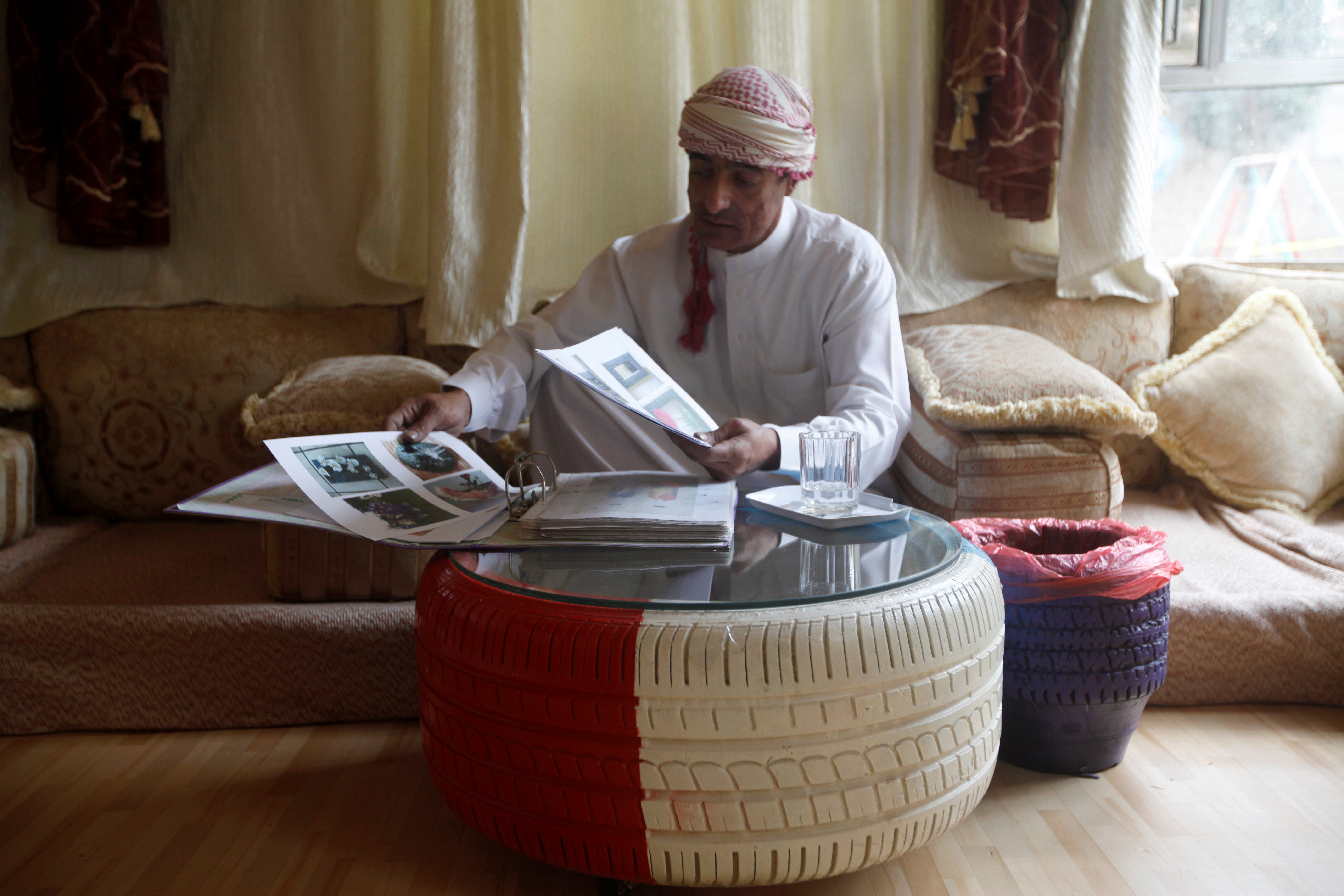 Yemeni furniture maker Soufian Noaman using a coffee table made from used tyre