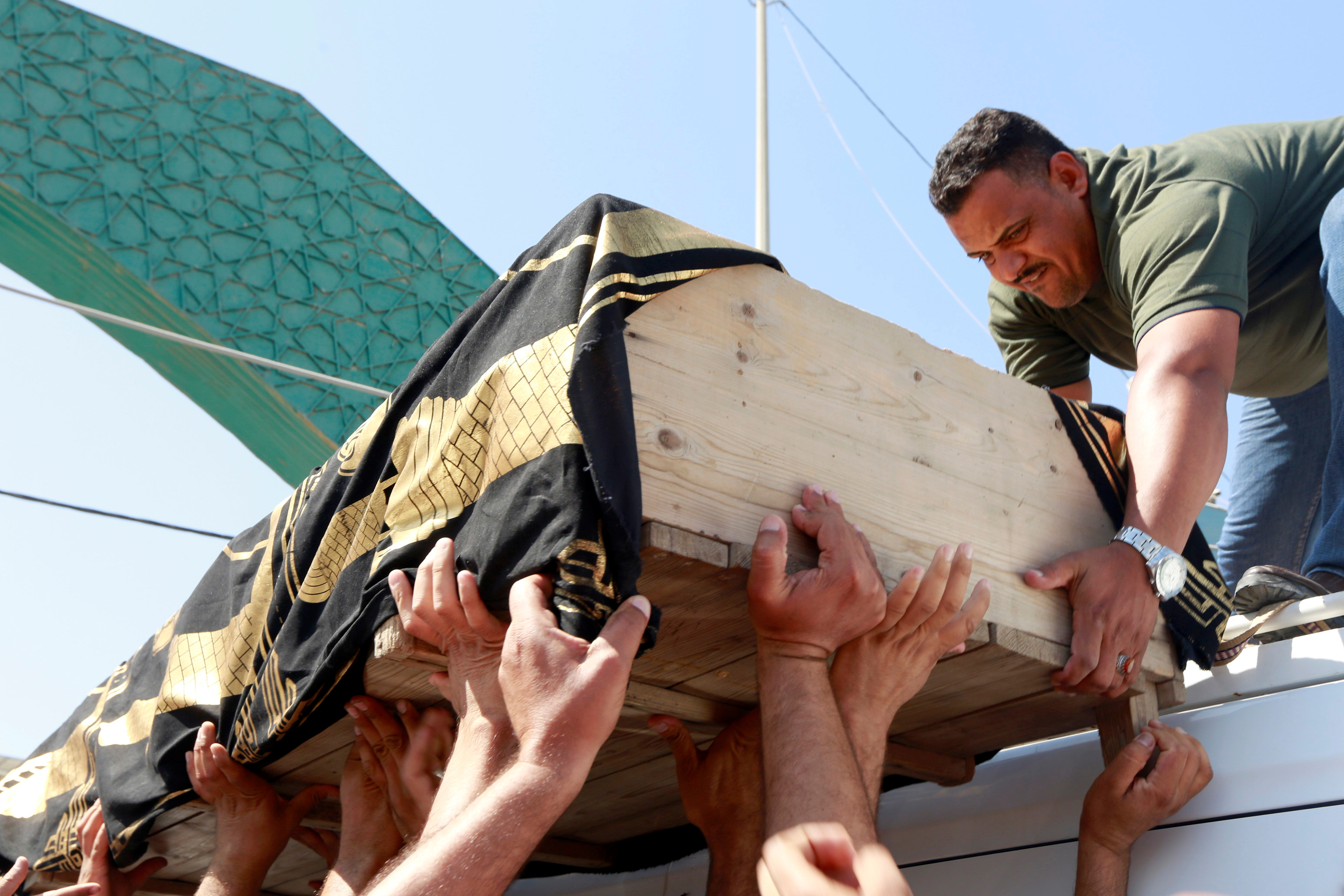 Relatives carry a coffin of a victim of a stampede at Shia Muslim religious rituals of Ashura during the funeral in the holy city of Najaf (Reuters)