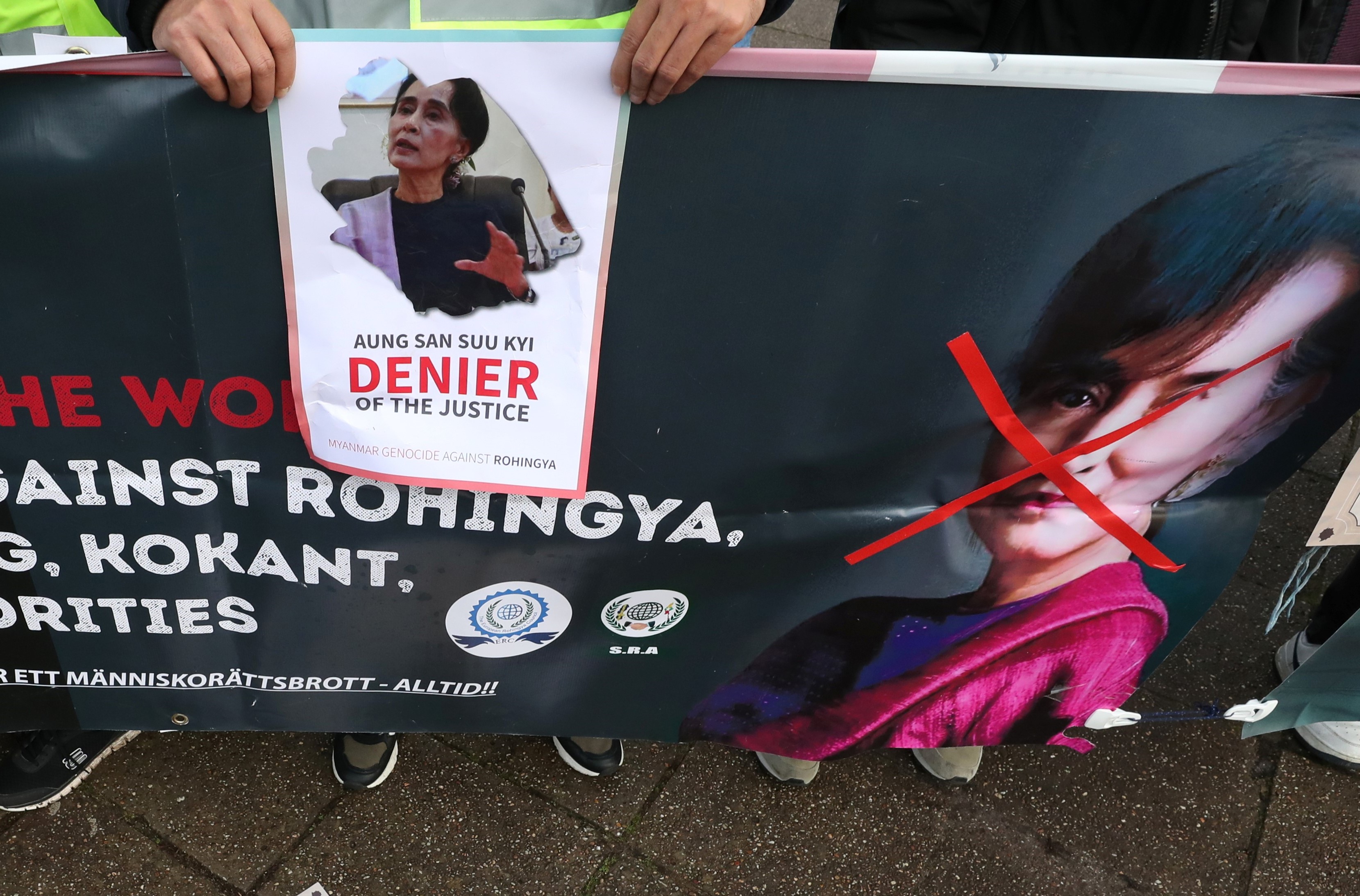 People protest against Myanmar's leader Aung San Suu Kyi on the second day of hearings in a case filed by Gambia against Myanmar alleging genocide against the minority Muslim Rohingya population, outside the International Court of Justice (ICJ) in The Hague, Netherlands December 11, 2019