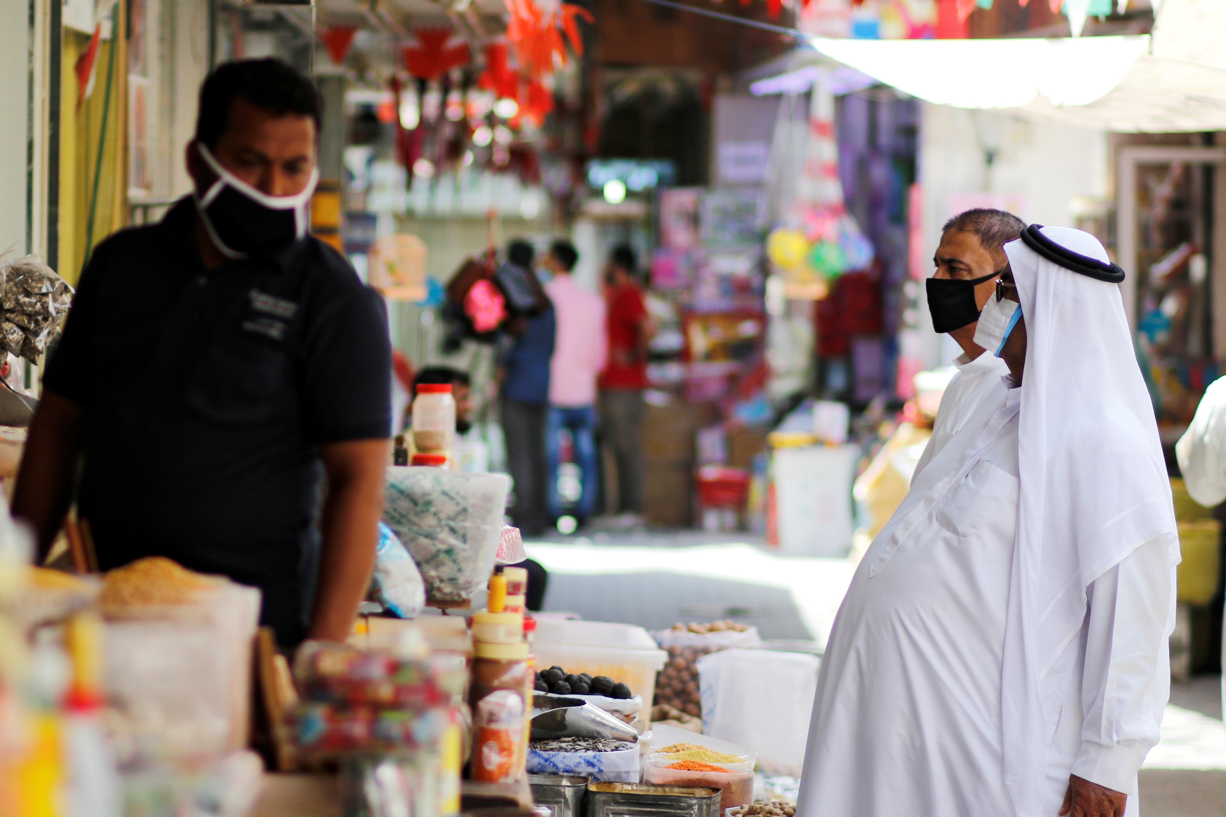 People wear protective face masks following the outbreak of the coronavirus disease (COVID-19), as they shop ahead of the holy month of Ramadan in Manama, Bahrain, April 23, 2020