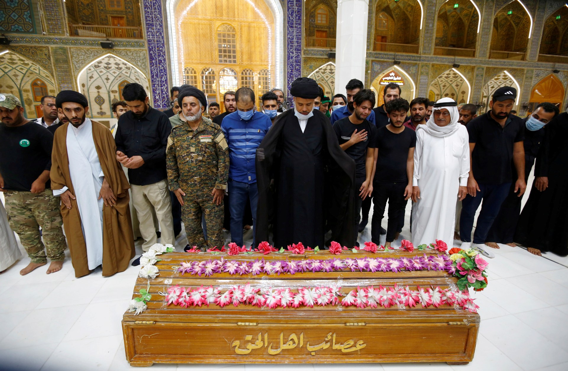 Mourners pray near the coffin of a member of the PMF, who was killed in clashes with Islamic State militants in Salah al-DIn province, during the funeral in the holy city of Najaf (Reuters)