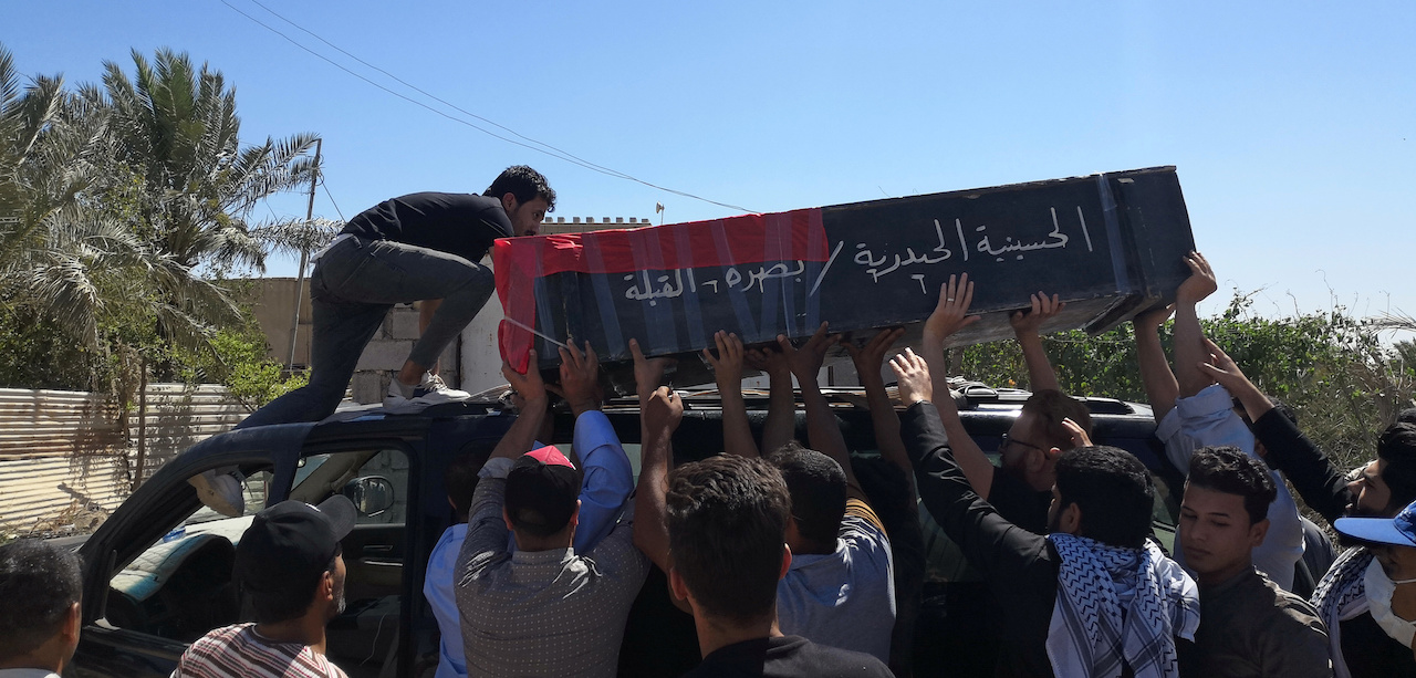 Mourners carry the coffin of an Iraqi demonstrator, who was killed during ongoing anti-government protests in Basra (Reuters)