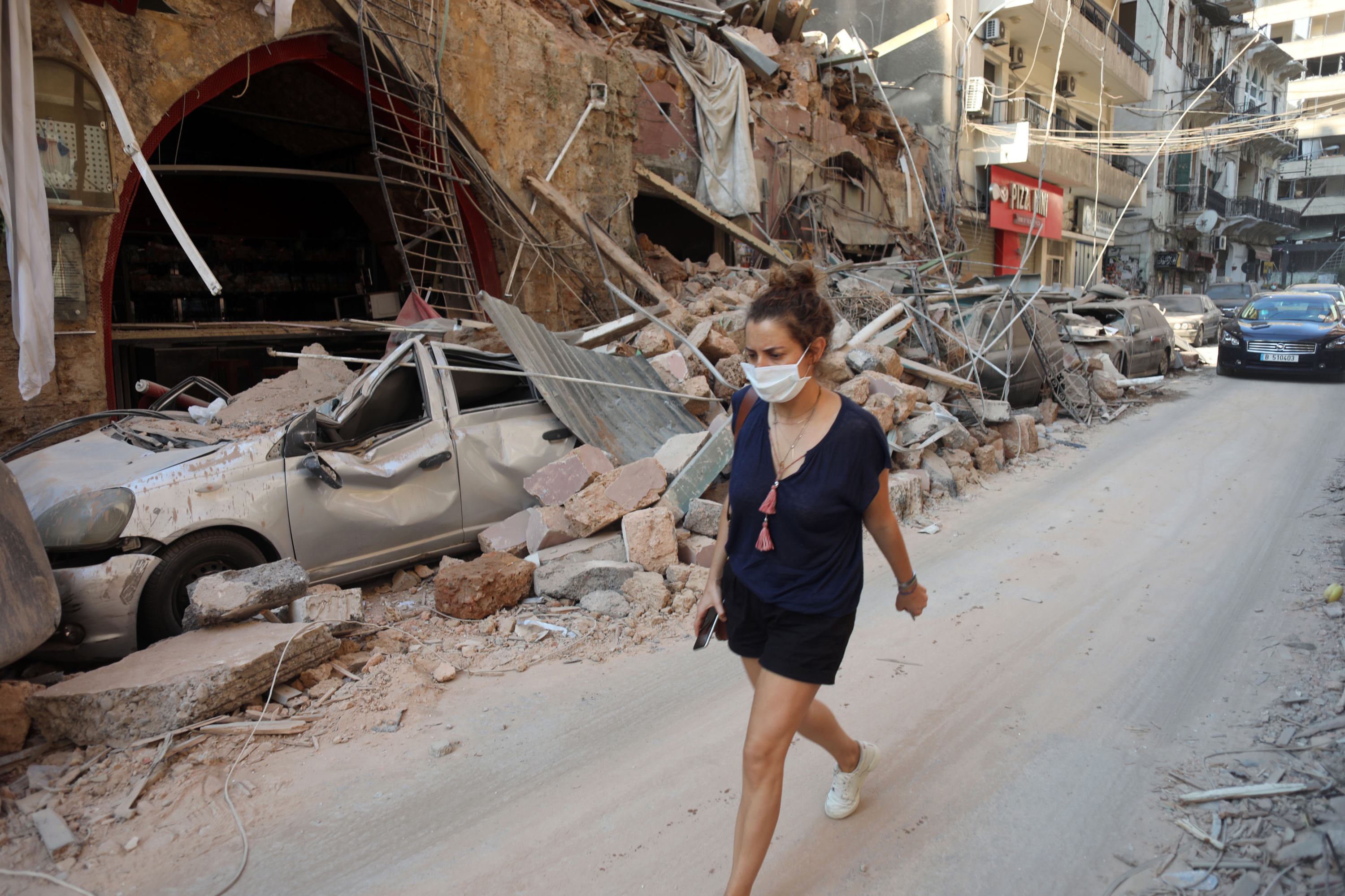A woman walks in the Gemmayze neighbourhood a day after the explosion (MEE/Hasan Shaaban)
