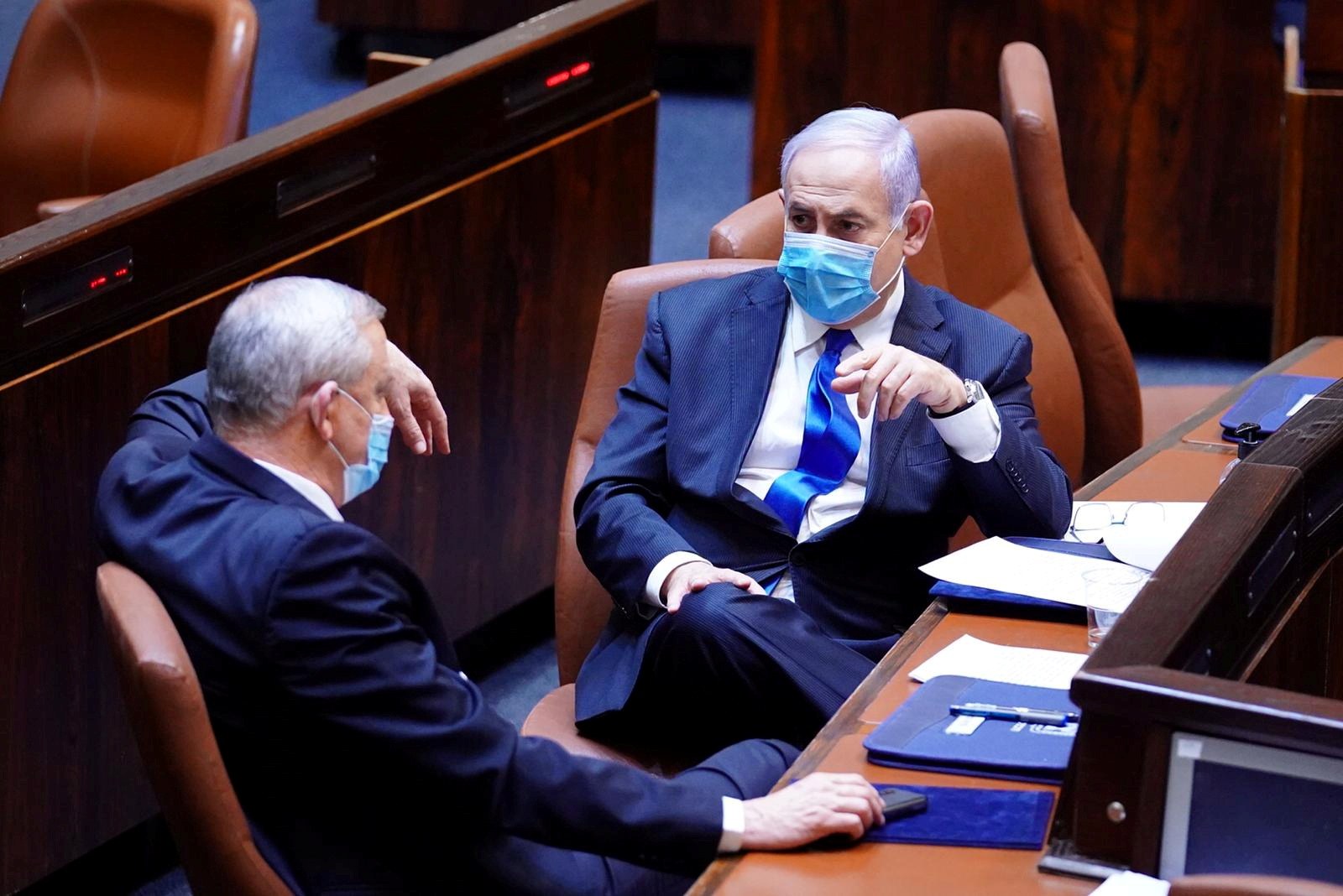 Israeli Prime Minister Benjamin Netanyahu and Benny Gantz talk in parliament in May (Reuters)