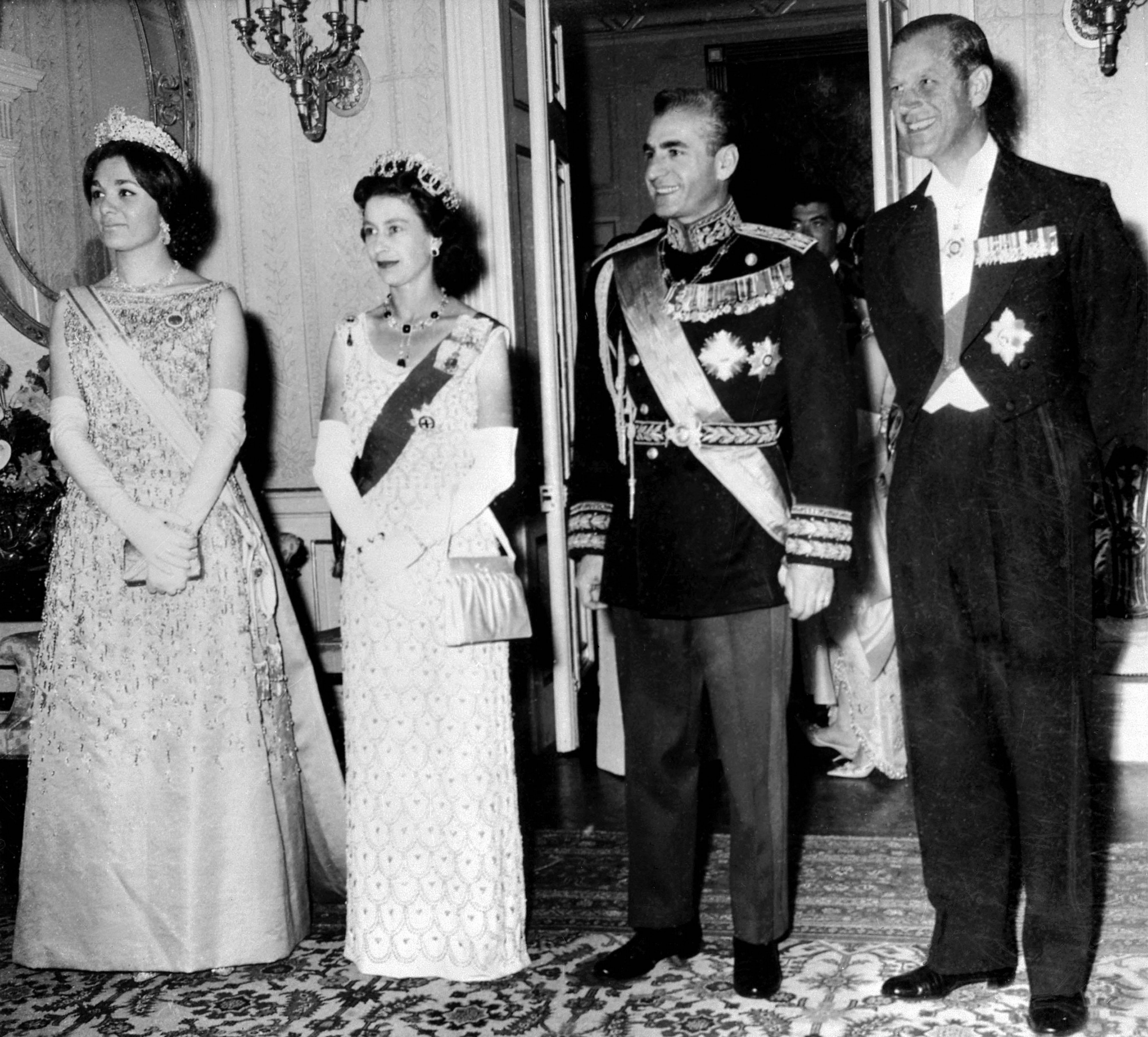 La reine Elizabeth II et le prince Philip posent avec le shah d’Iran Mohammad Reza Pahlavi et son épouse Farah Pahlavi lors de leur visite d’État à Téhéran en mars 1961 (AFP)