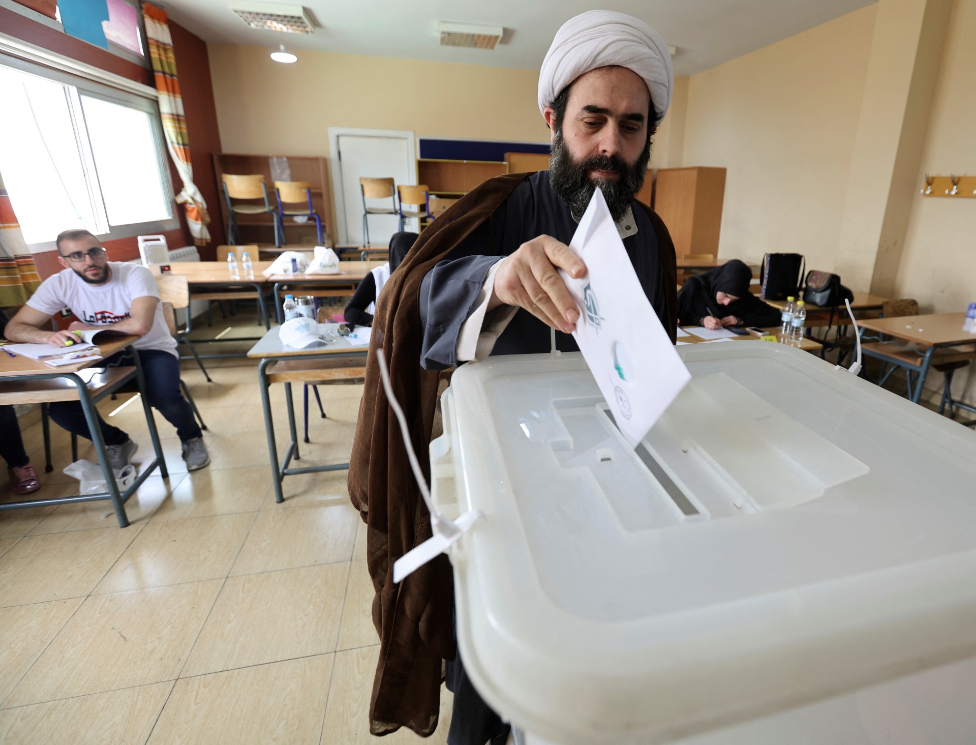 A muslim cleric casts his vote at a polling station, during the parliamentary election, in Khiam, near the border with Israel, southern Lebanon (Reuters)