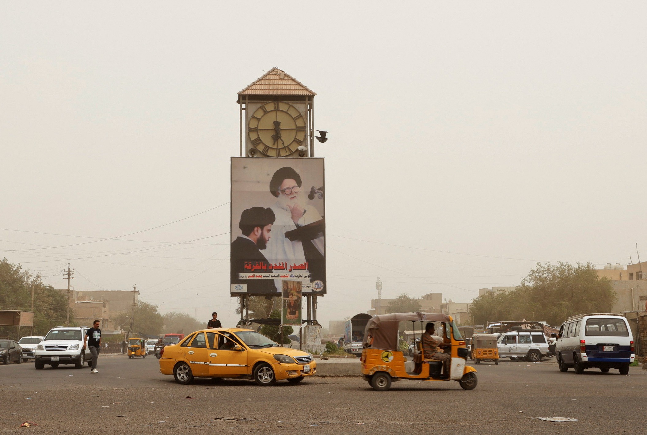 A poster of the late Grand Ayatollah Mohammed Sadiq al-Sadr and his son Muqtada al-Sadr is pictured in the Sadr City district of Baghdad (Reuters)