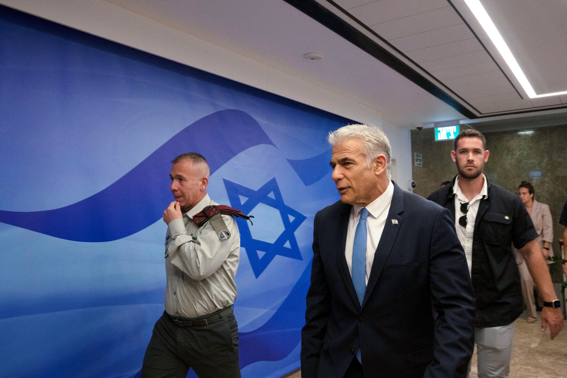Israel's Prime Minister Yair Lapid walks as he attends the weekly cabinet meeting in Jerusalem, 14 August (Reuters)