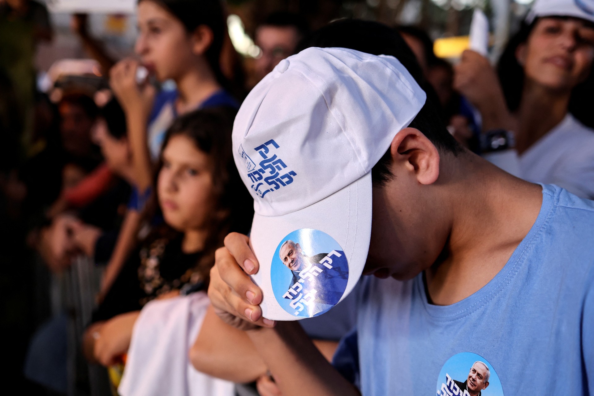 A supporter of Benjamin Netanyahu wears a hat displaying the Likud party slogan at a campaign event in the run up to Israel's elections in Ramat Gan (Reuters)