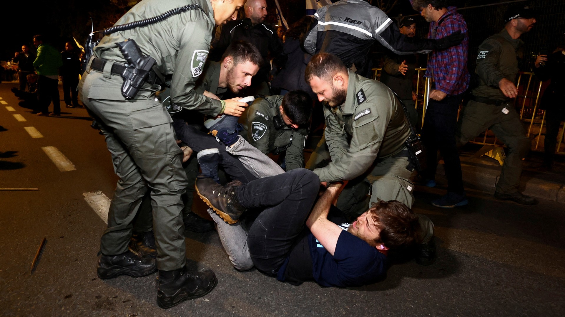 Police officers detain a protester in Jerusalem (Reuters)