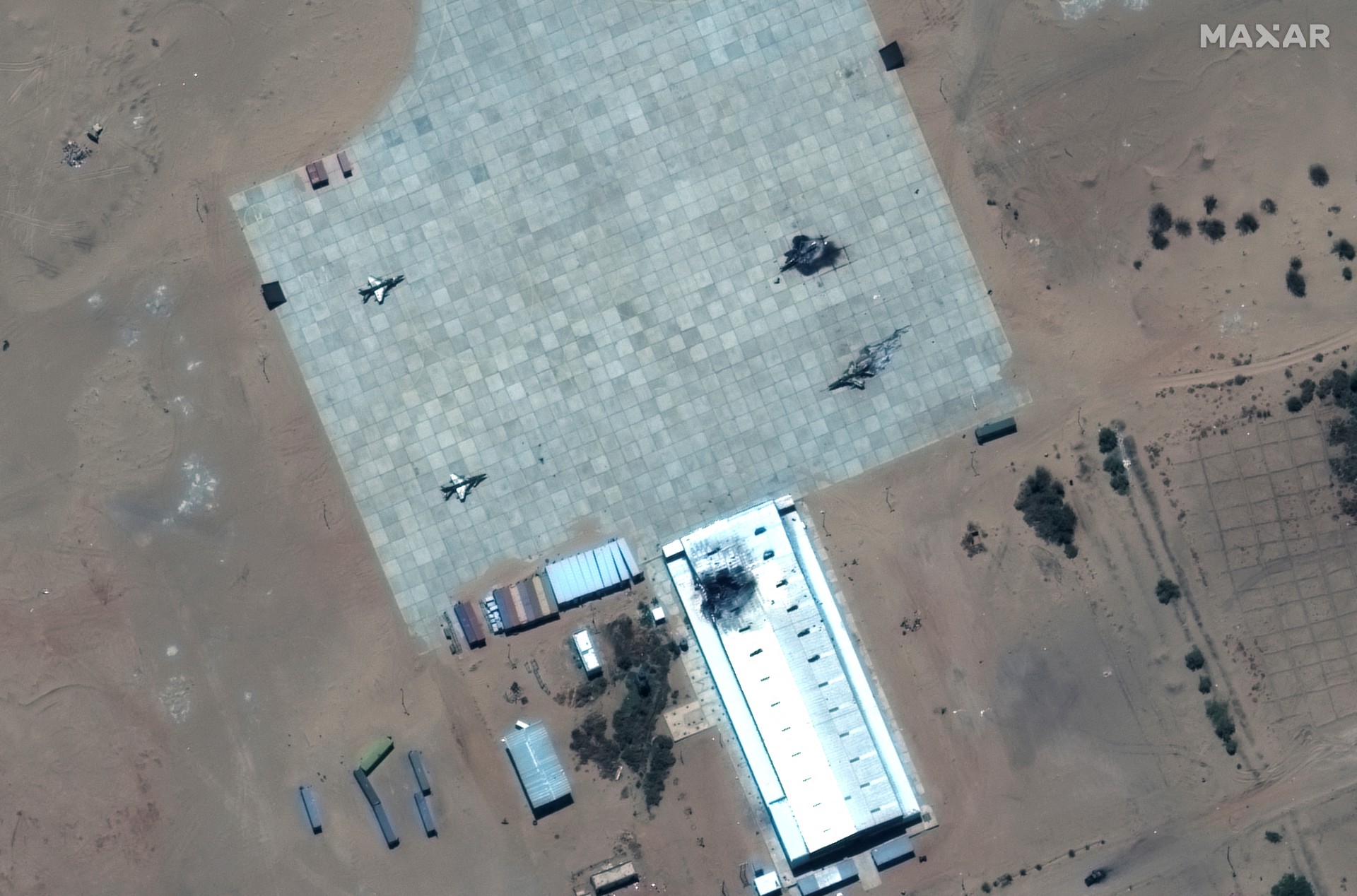 A satellite image shows destroyed FTC-2000 fighter aircraft and damaged hangar at the Merowe Airbase, Sudan, 18 April (Reuters_