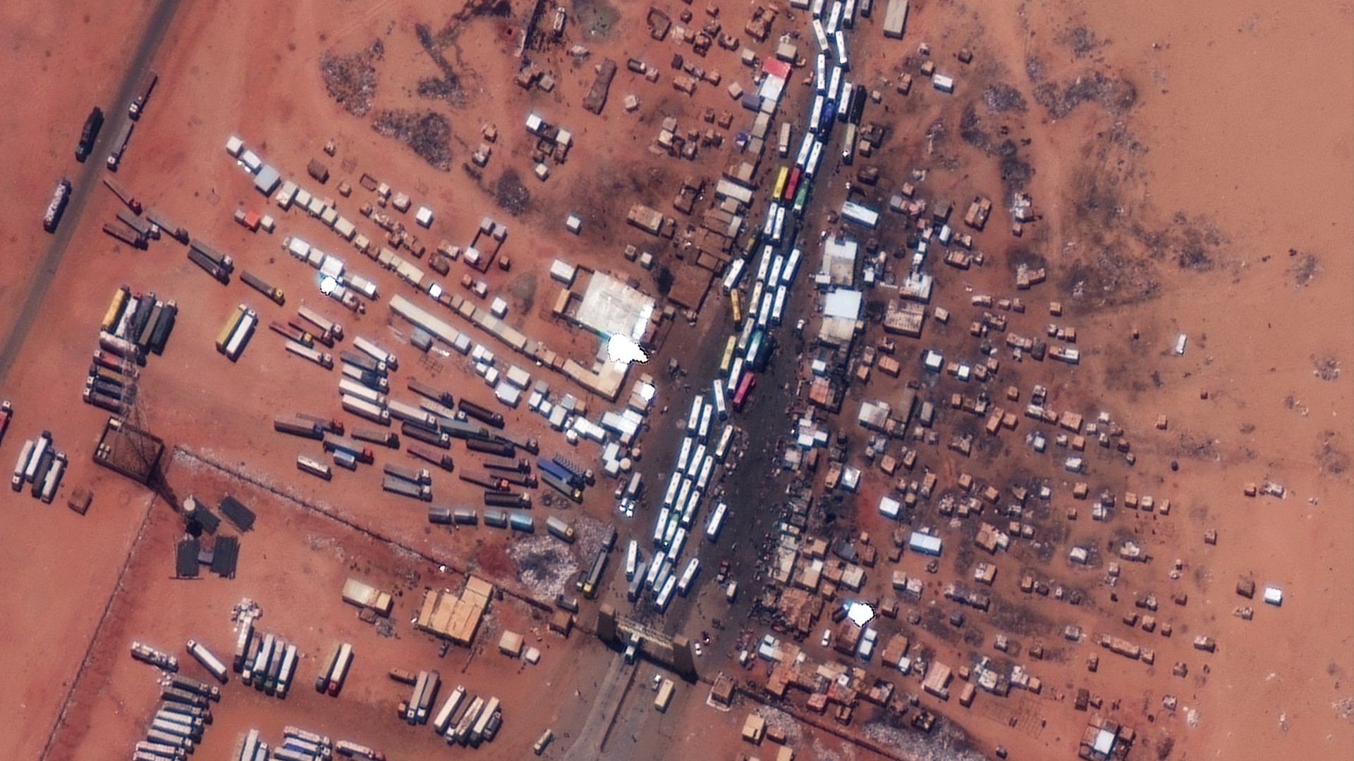 A satellite view shows buses as they wait at the Argeen border between Egypt and Sudan, 28 April (Reuters)