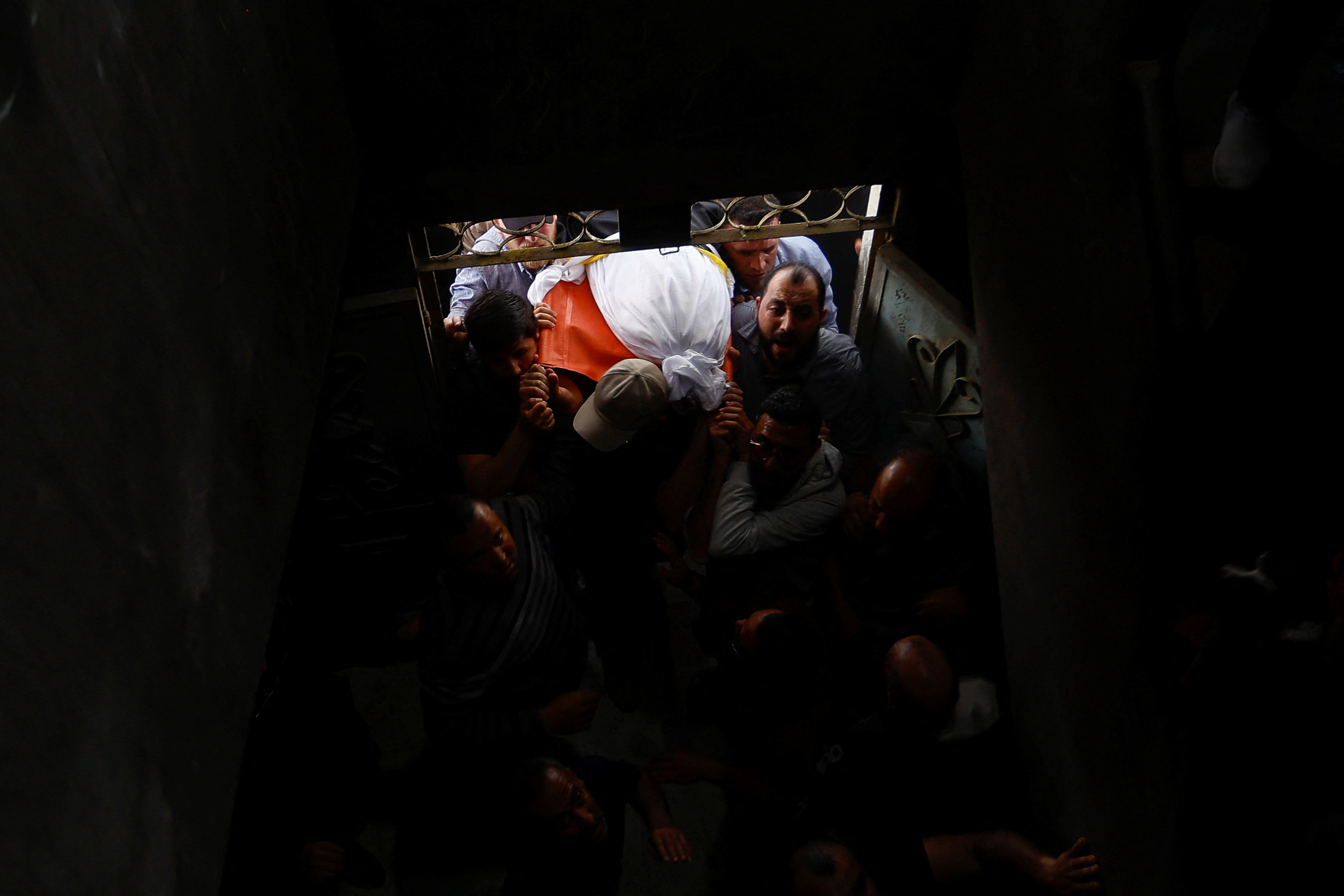 Mourners attend the funeral of Islamic Jihad commander Ali Ghali and his brother Mahmoud who were killed in an Israeli strike in the Gaza Strip 11 May 2023 (Reuters)