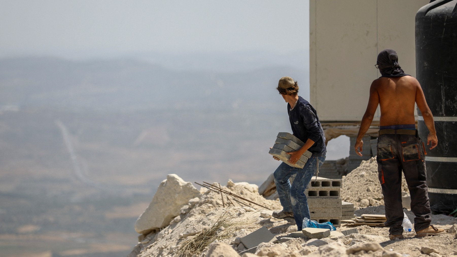 Israeli settlers erect a structure for a new Jewish seminary school, in the settler outpost of Homesh in the Israeli-occupied West Bank 29 May (Reuters)