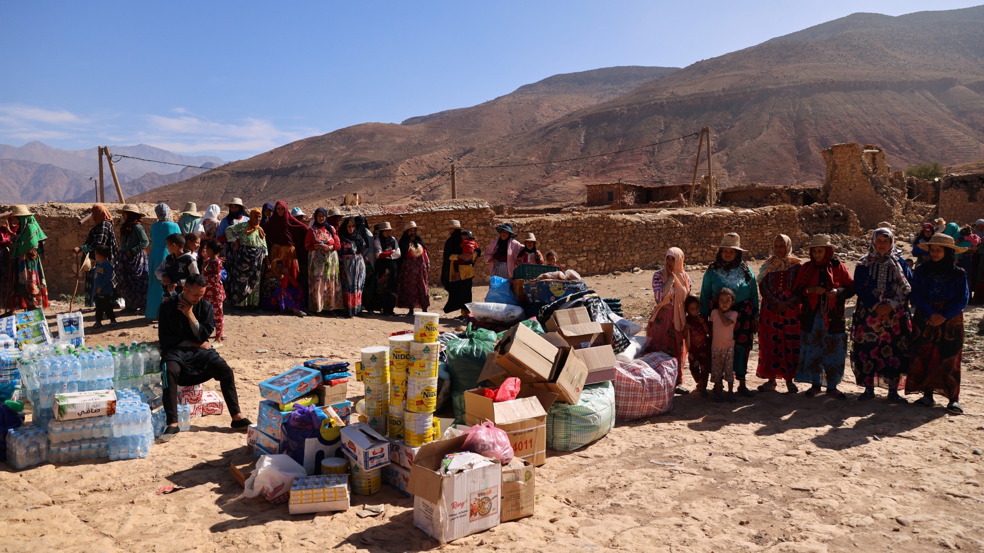 Women wait for donations in Ighil, 11 September (Reuters)