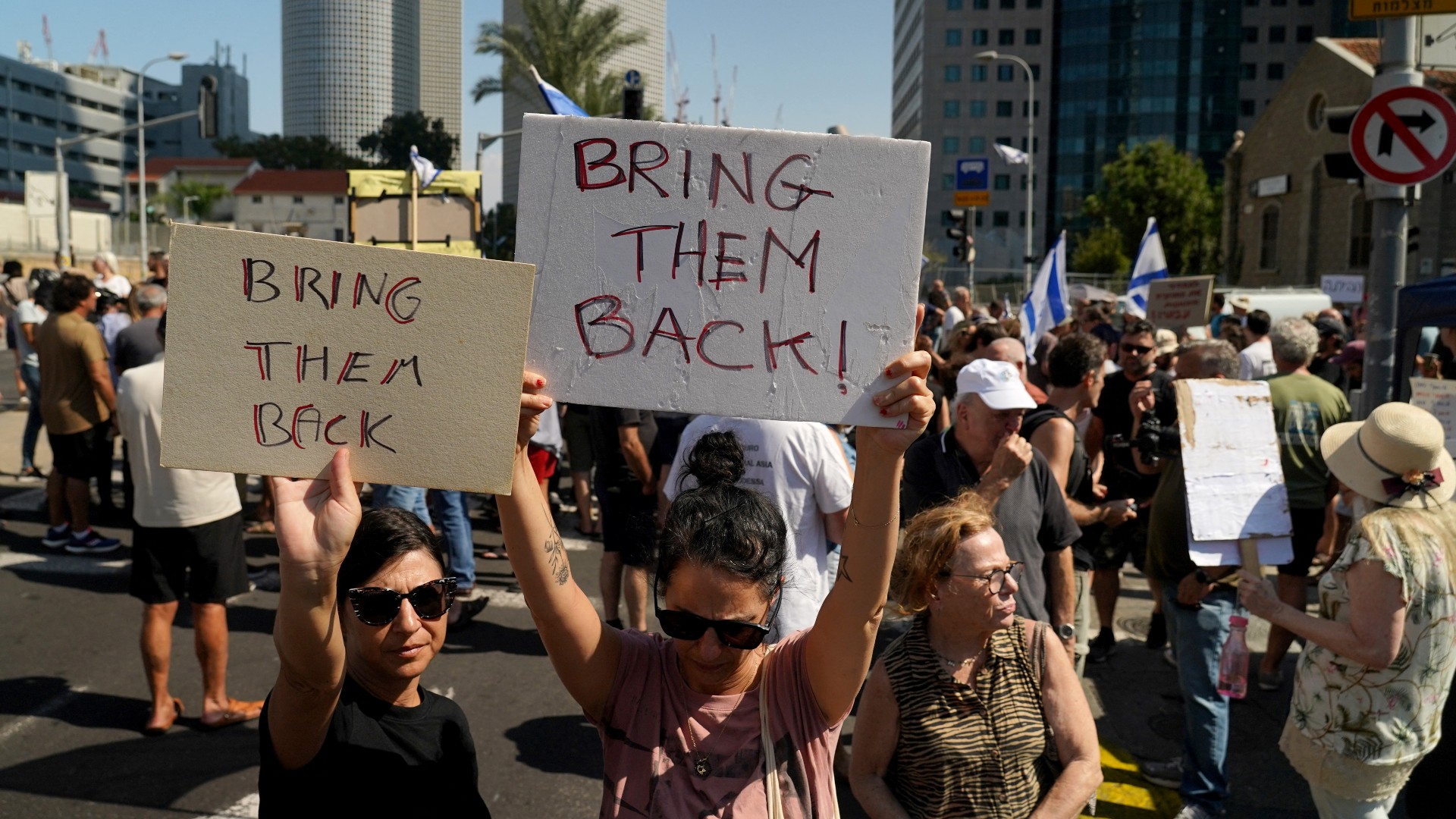 Israelis attend a demonstration, calling for the return of loved ones who were taken as captives, in Tel Aviv on 14 October (Reuters)