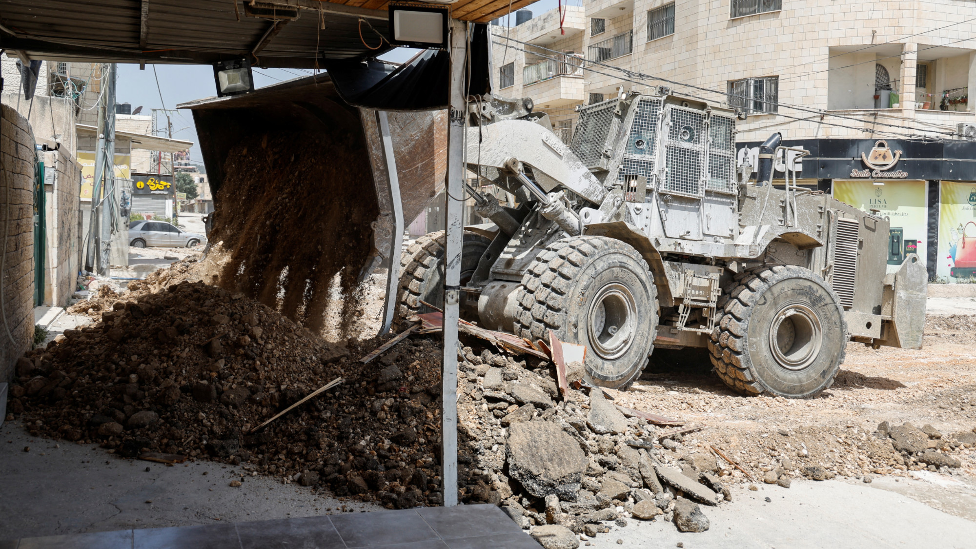 An Israeli military machinery razing roads in Jenin, in the occupied West Bank, 21 May 2024 (Reuters/Raneen Sawafta)