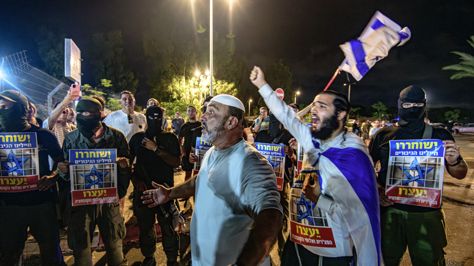  Israeli rioters break into the Beit Lid military base holding signs that read 'The hero soldiers should be released', following the arrest of soldiers accused of sexually abusing a Palestinian detainee, in Beit Lid, on 29 July (Matan Golan/Sipa USA)