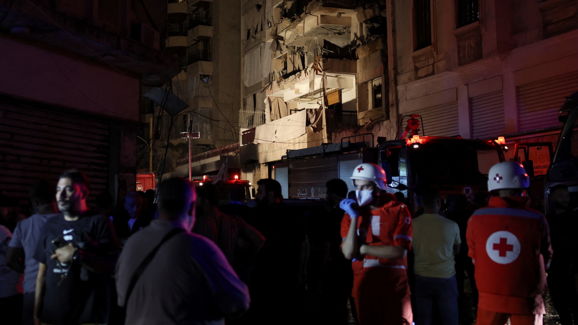 Members of the Red Cross stand near a damaged building at the site of an Israeli air strike in Ras Al- Nabaa, in Beirut, Lebanon, October 10, 2024