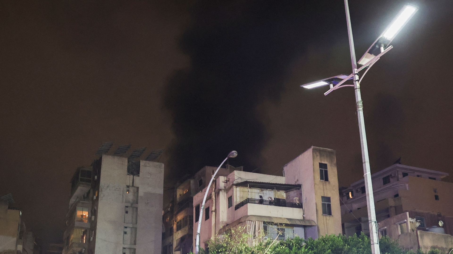 A building stands on the street while smoke rises after an Israeli air strike in Beirut, Lebanon, October 10, 2024.