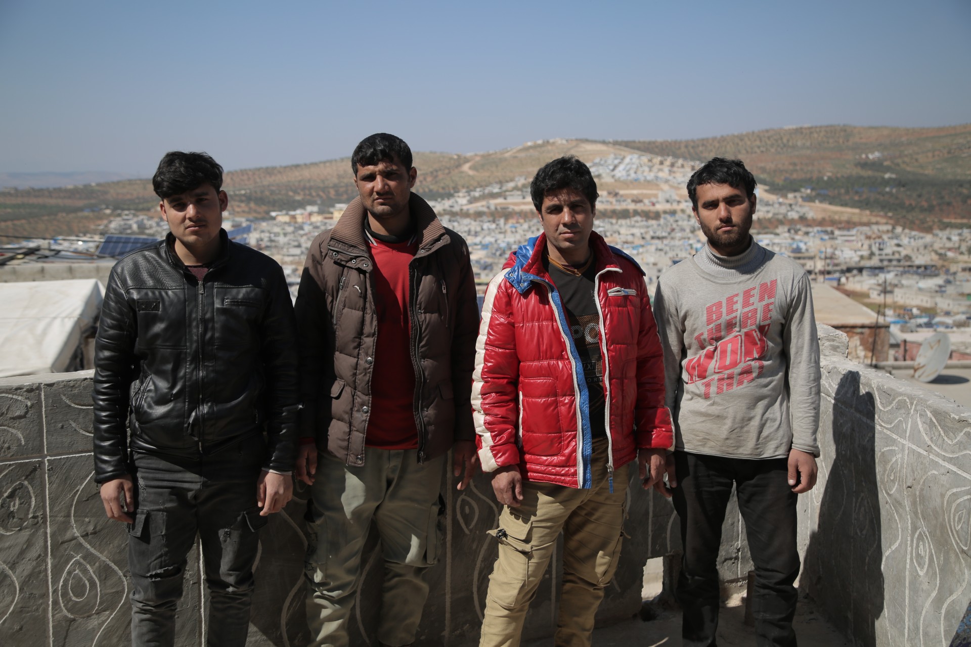 Four Afghan youths in the Qah area of Syria's Idlib (MEE)