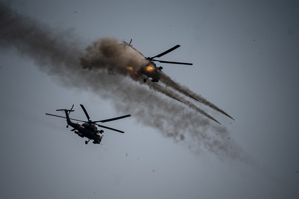 A Russian army Mi-28 helicopter launches rockets during joint military exercises with Chinese and Iranian troops at the Raevsky range in southern Russia, 23 September 2020 (AFP)