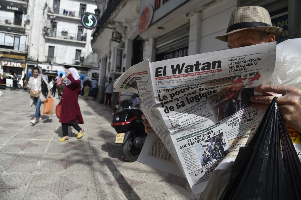 A man reads an Algerian French-language newspaper in the capital Algiers on 16 September 2019